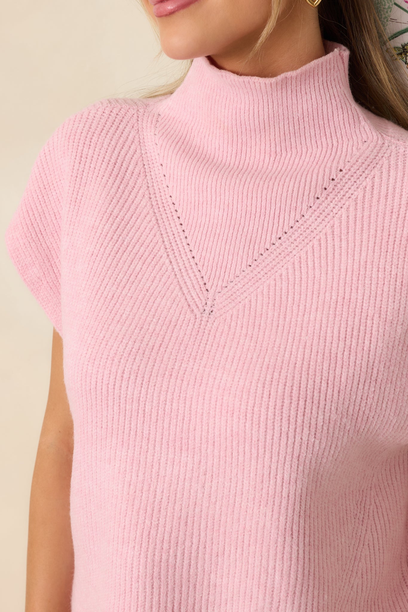Tight view of the ribbed knit stitching across the chest, showcasing the subtle raised knit design on the light pink fabric.