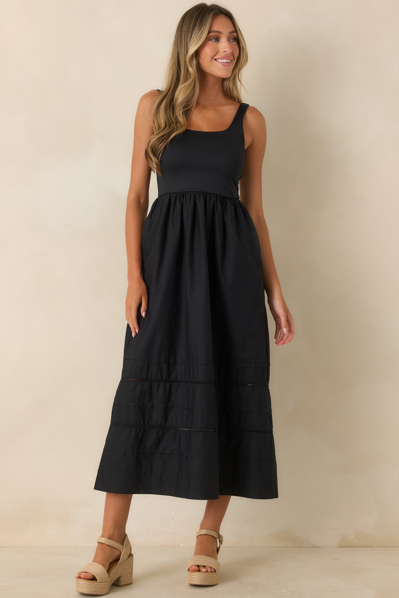 Timeless dress featuring a fitted upper silhouette and textured inset panel detailing near the hem.