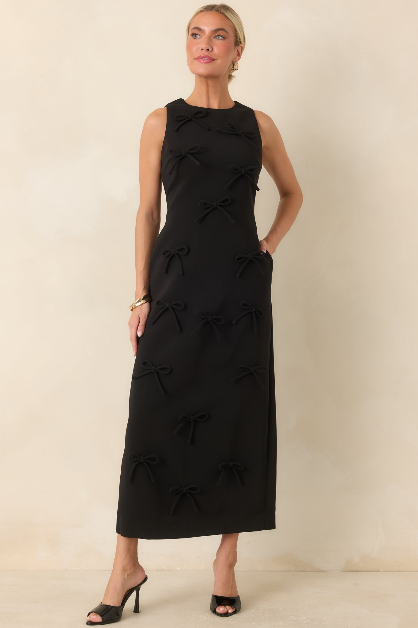 Tonal bow embellished maxi dress with a sleek skirt, structured bodice, and polished sleeveless design.