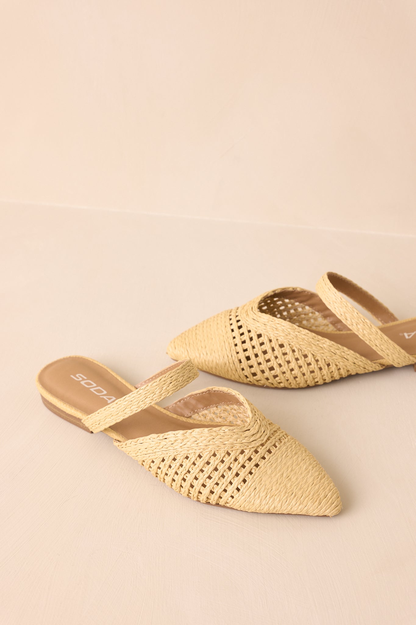 Top-side angled view showing the woven texture and vamp strap placement.