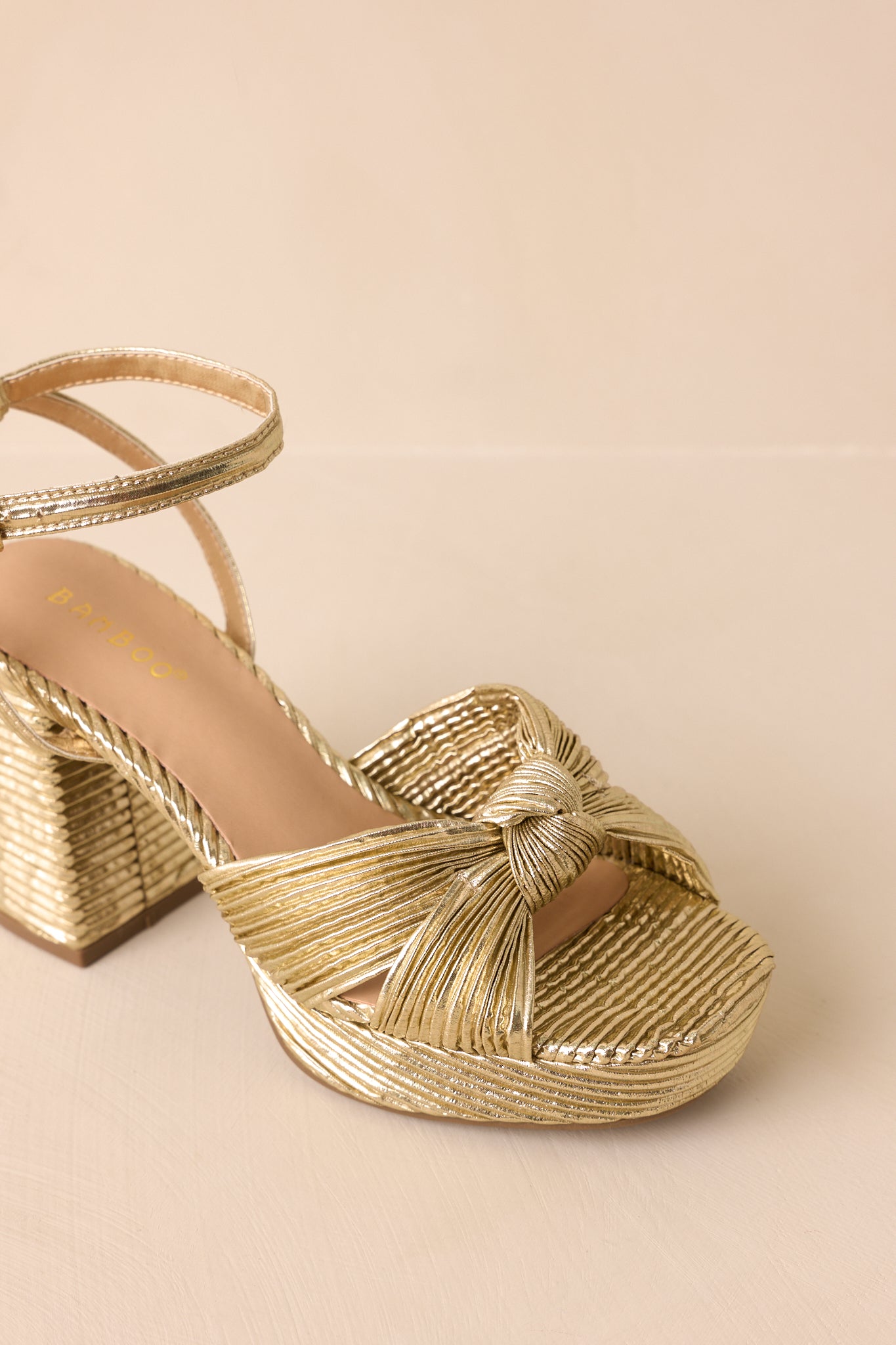 A top-down angle showing the pleated straps, knot detail, and cushioned insole.