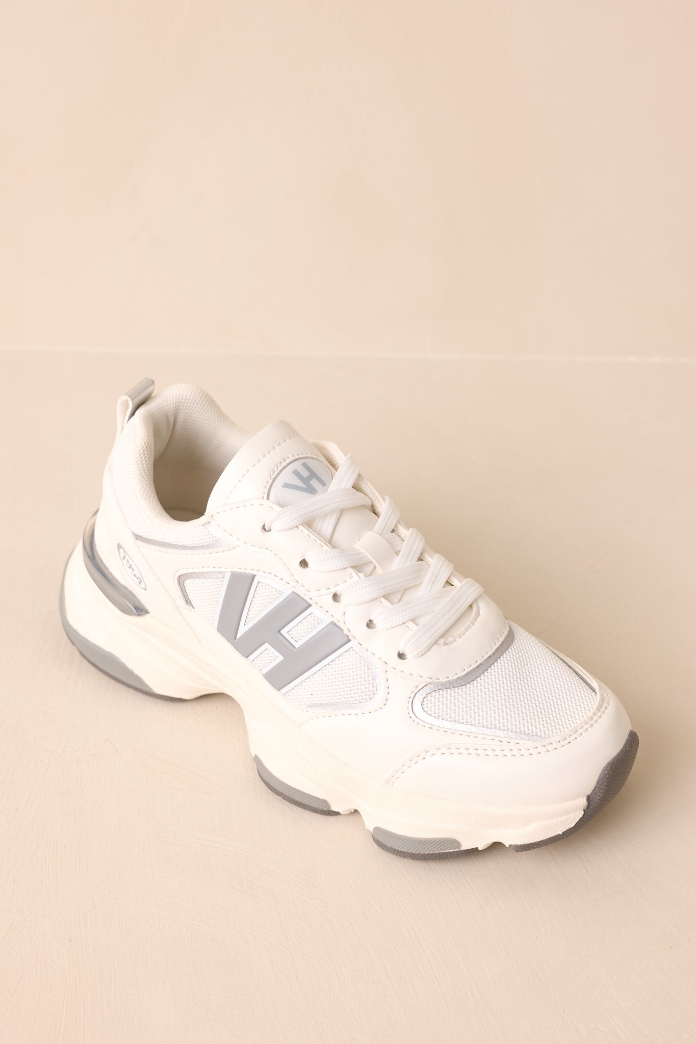 Top-down perspective highlighting lace-up front, rounded toe, and clean contrast between white and grey panels.
