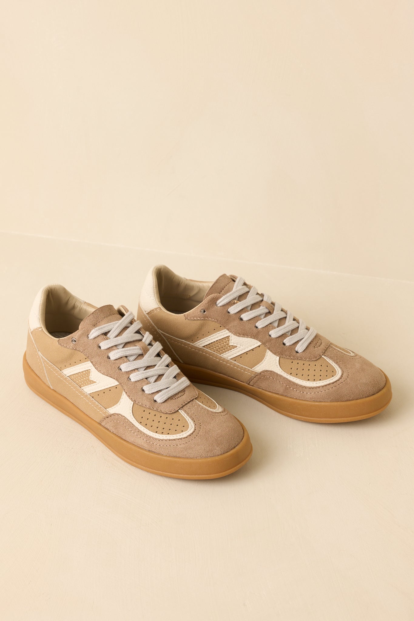 Top-down angle emphasizing the laces, rounded toe, and color-contrast upper of the sneakers.