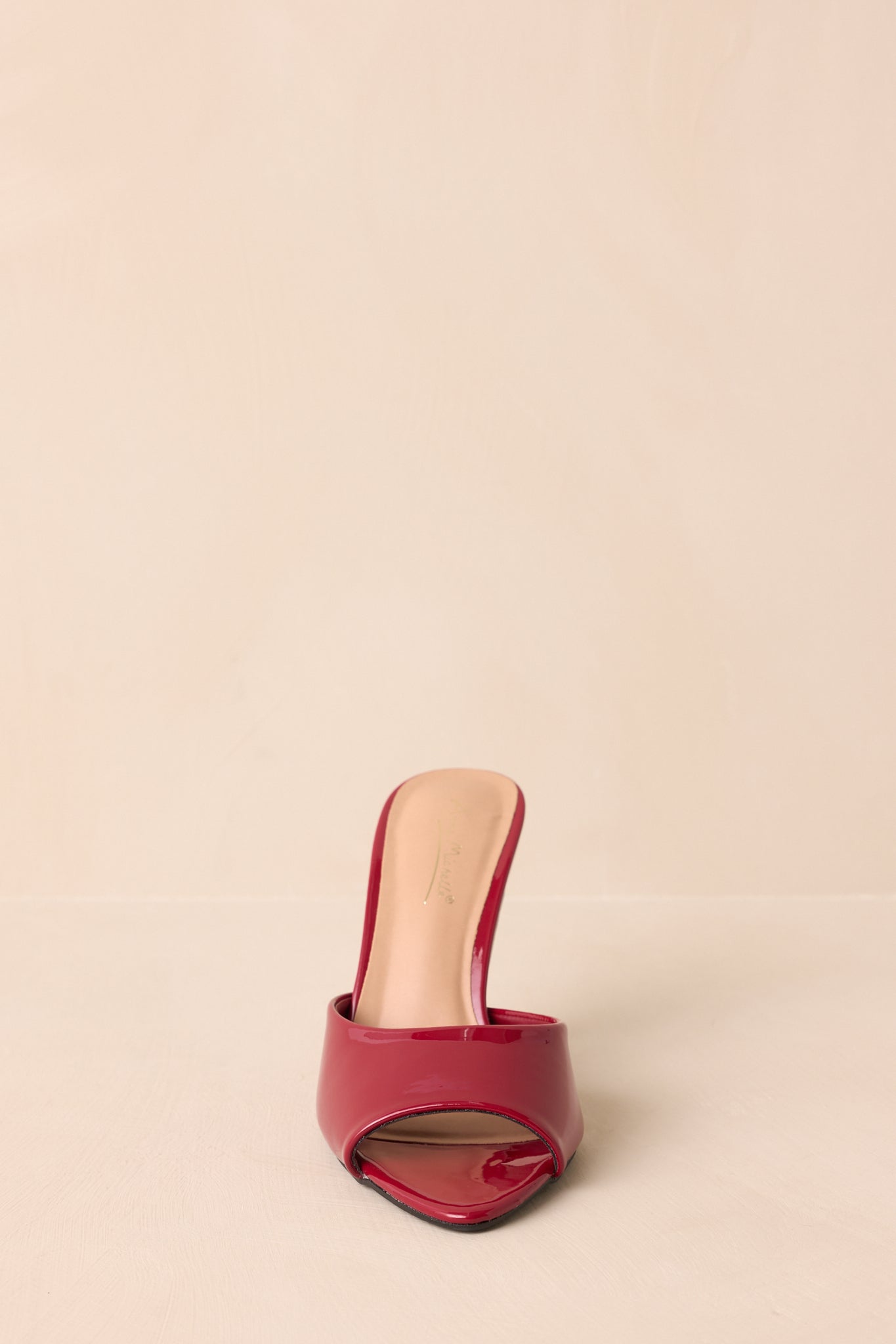 Top-down view of red faux leather mule heels highlighting open-toe style.