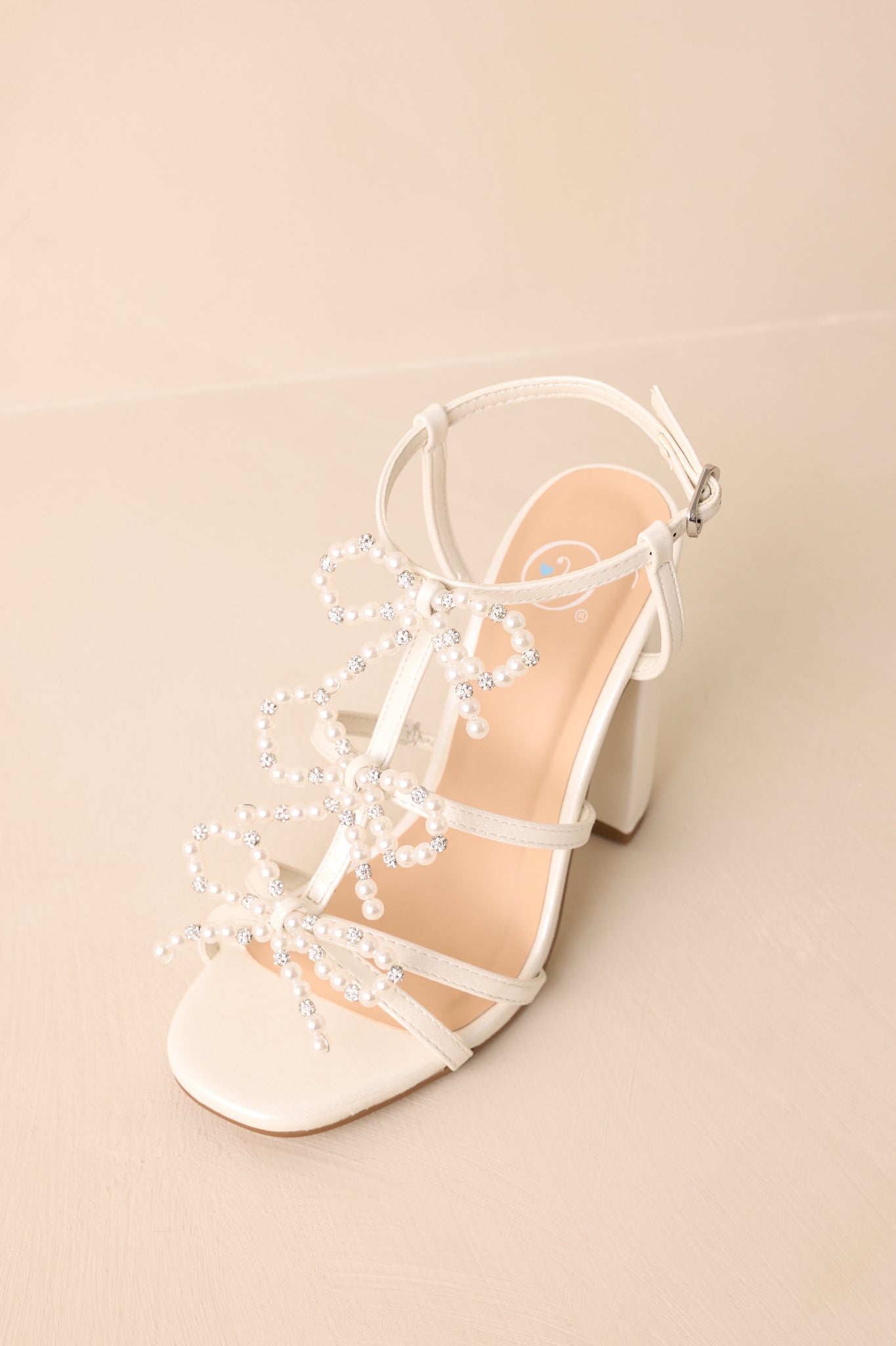 A top-down view showing the positioning of the ankle strap and toe embellishments.