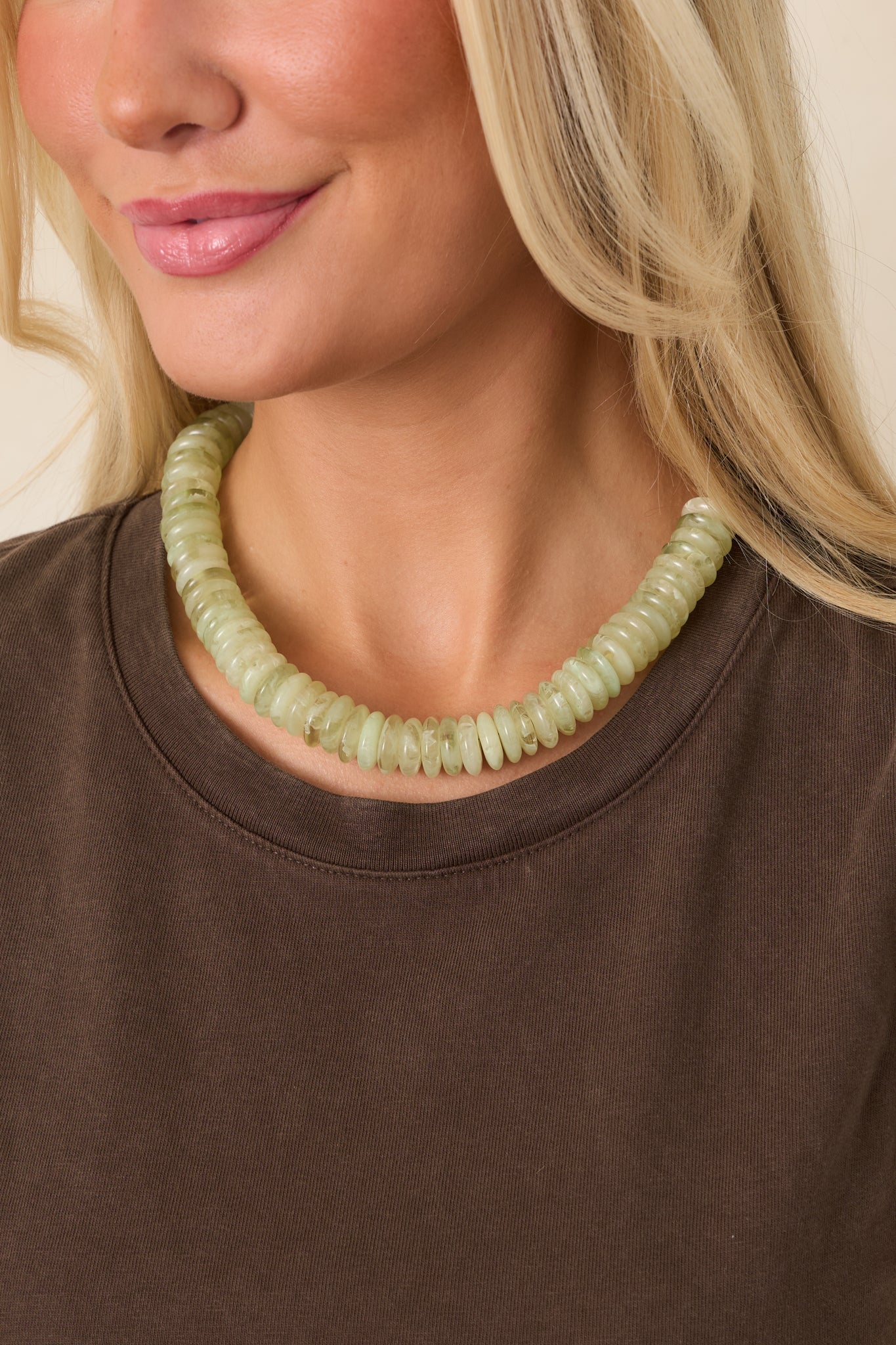 Chunky necklace featuring translucent pale green disc beads with softly irregular shapes and natural-looking variations in tone.