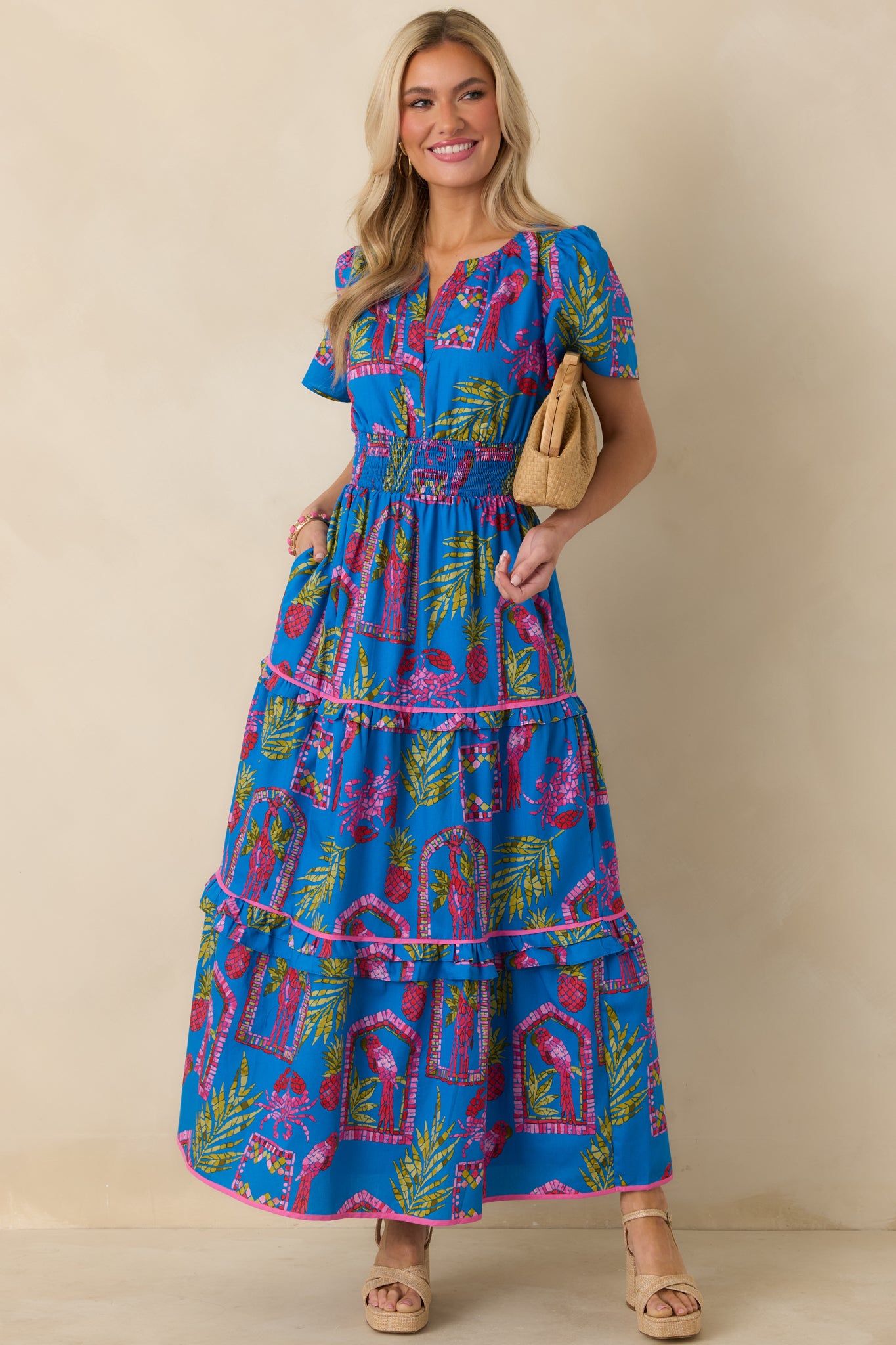 Tropical mosaic blue dress with tiered maxi skirt and airy short sleeves for a relaxed silhouette.