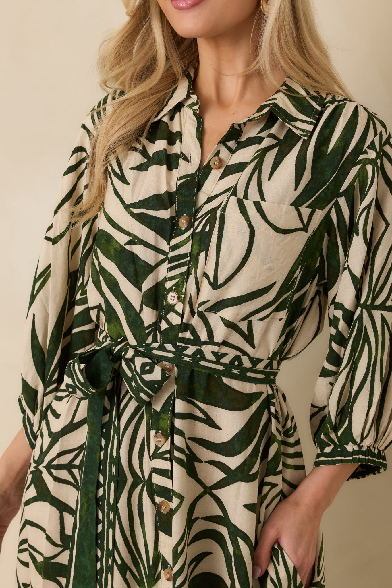 Close-up detail of tropical print maxi dress highlighting collared neckline, single breast pocket, and button closure.