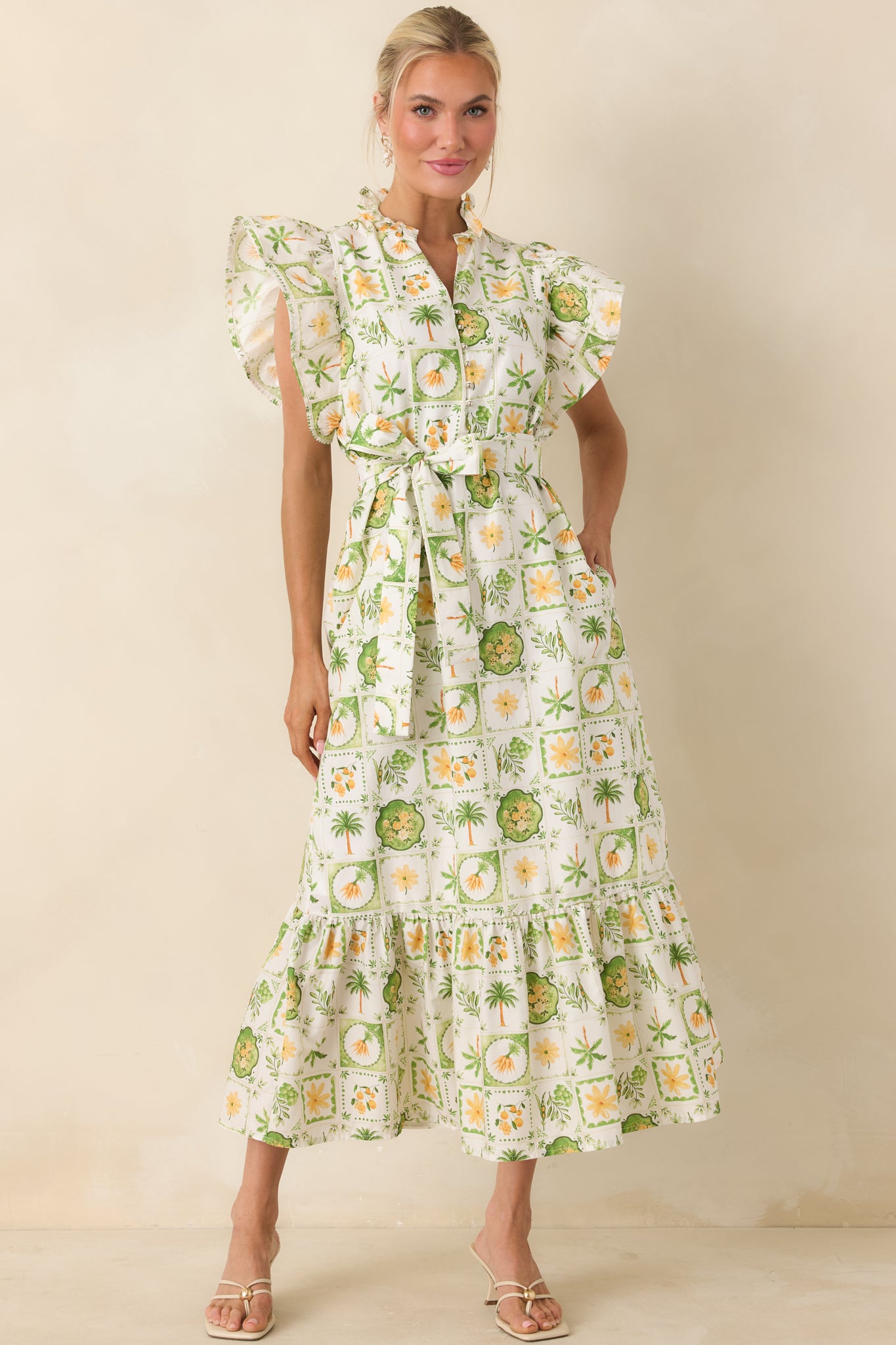 Tropical-print maxi dress with ruffle-trimmed collar and partial button-front placket.