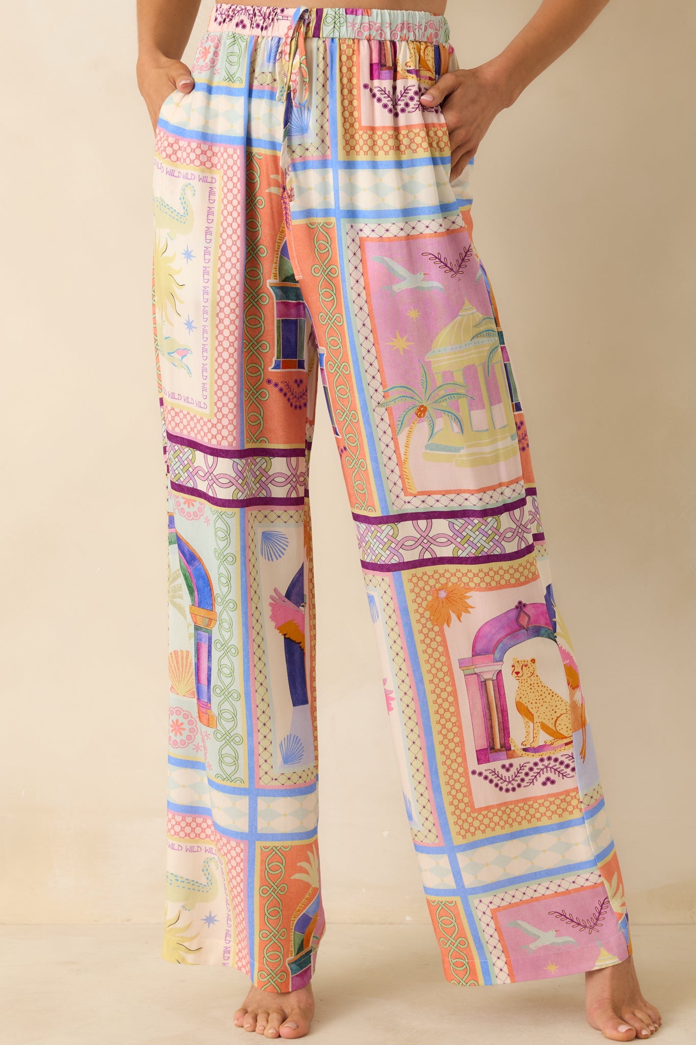 Front view of the tropical print pants emphasizing the elastic waist and vibrant tile design.