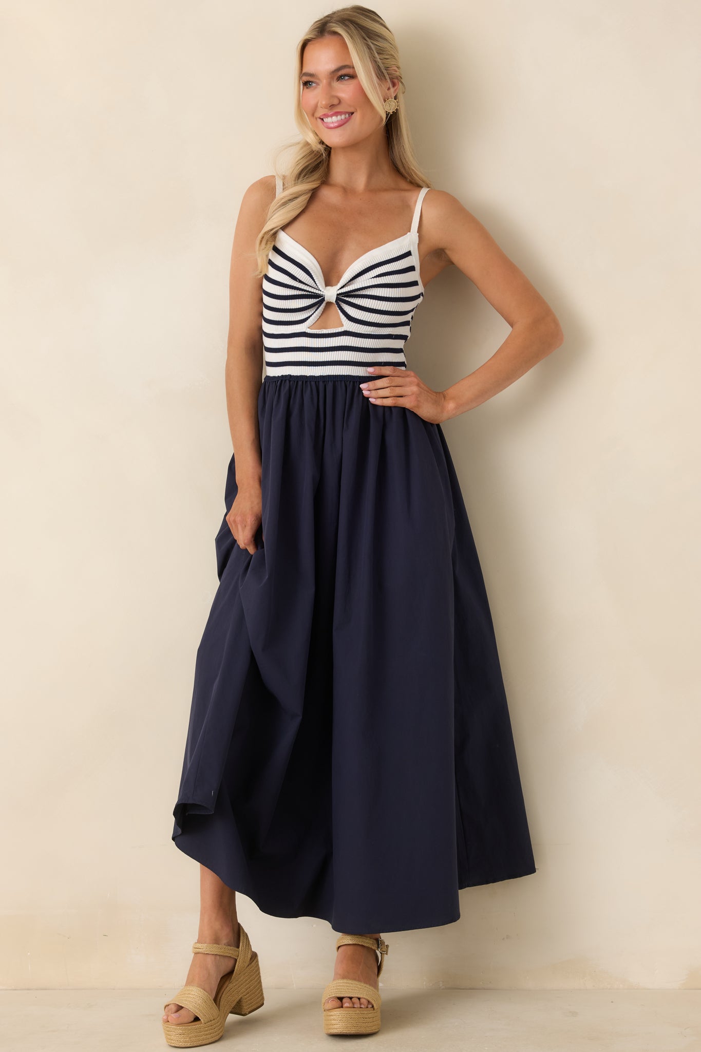Twist-front midi dress with subtle cutout, adjustable straps, and full gathered skirt.