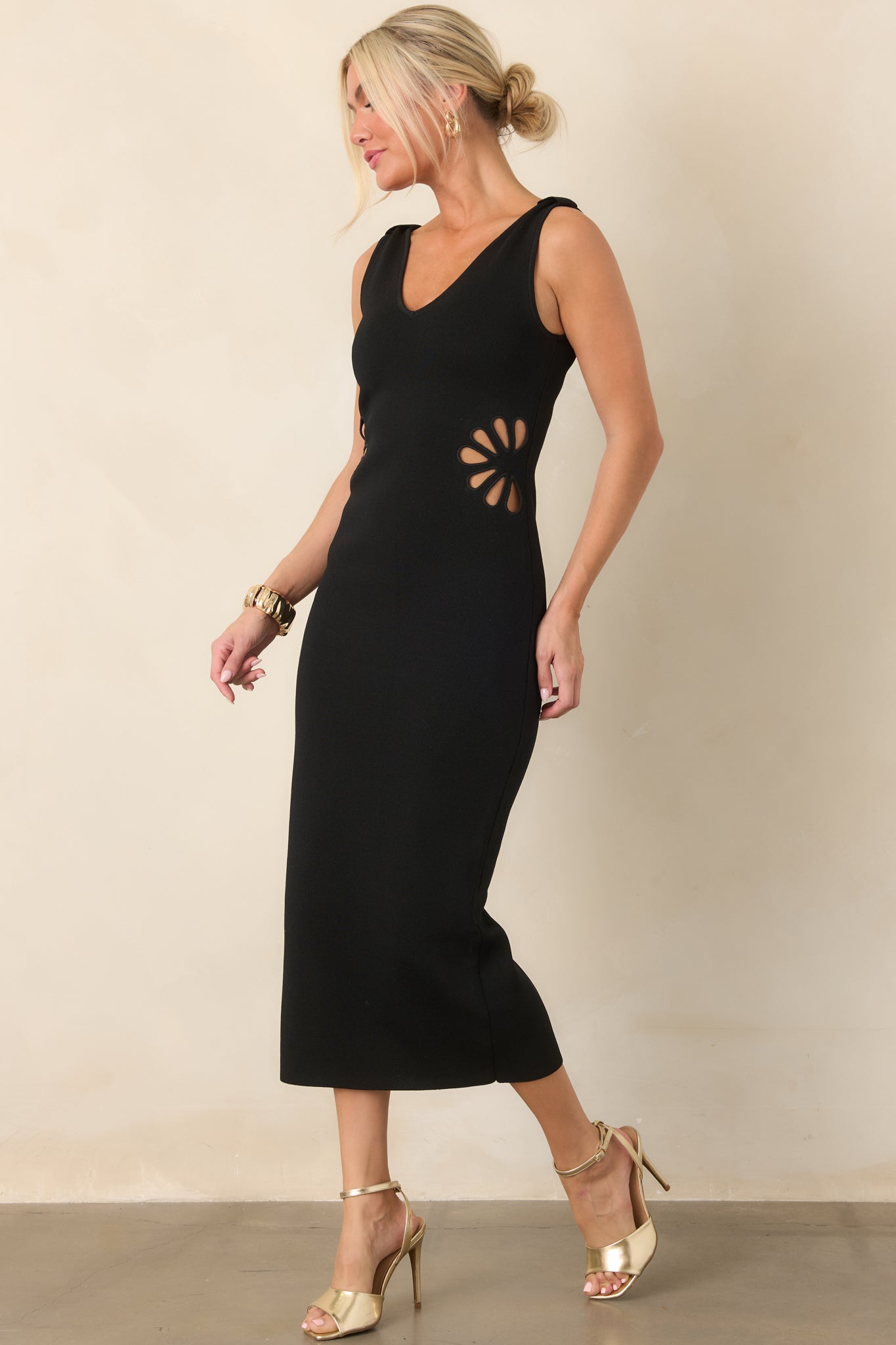 Streamlined stretch-knit dress with a flattering V-neckline, wide straps, and distinctive side waist cutouts shaped like flowers.