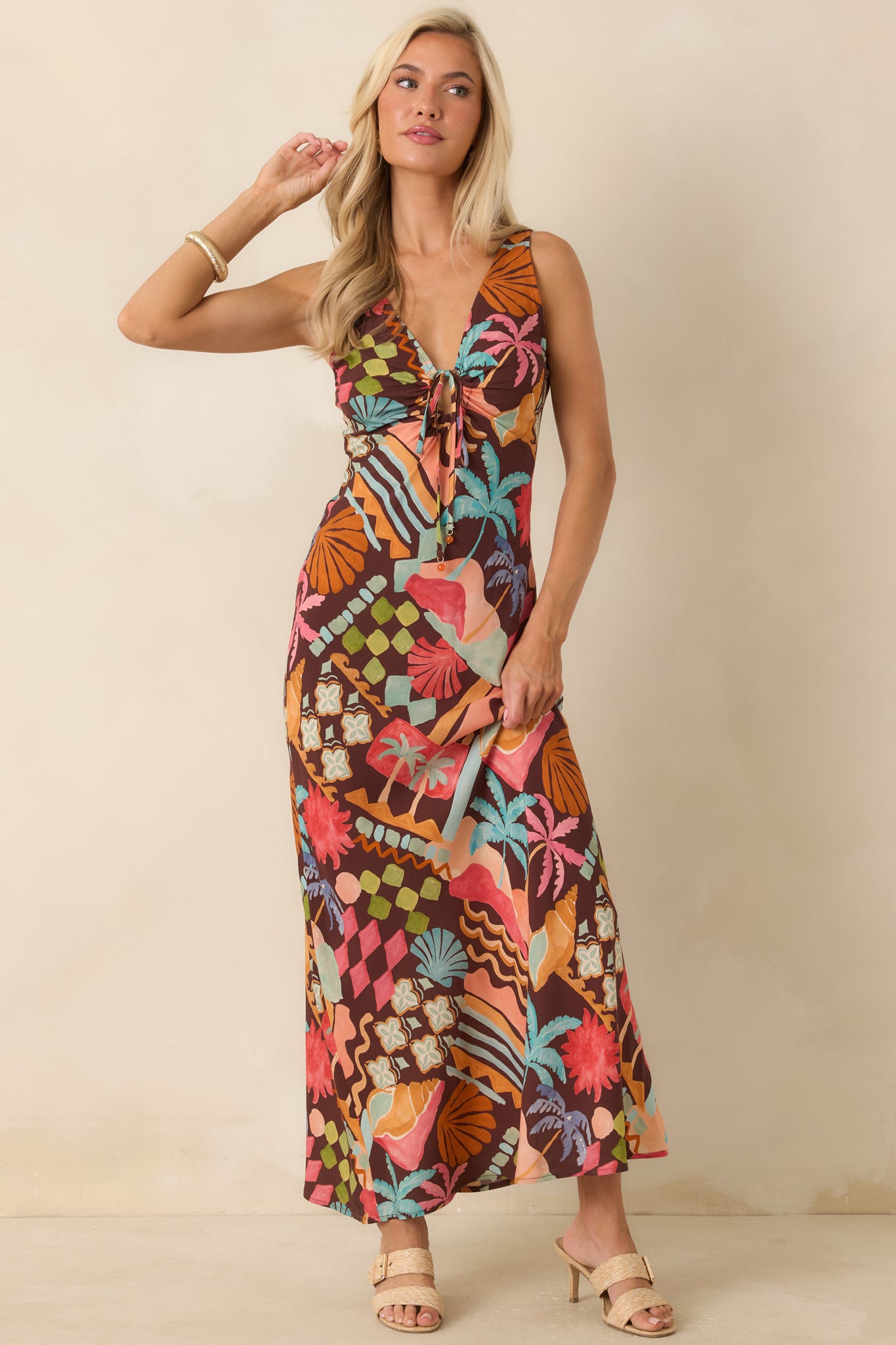 Vacation-inspired midi dress featuring a whimsical coastal print and an easy, graceful drape through the skirt.