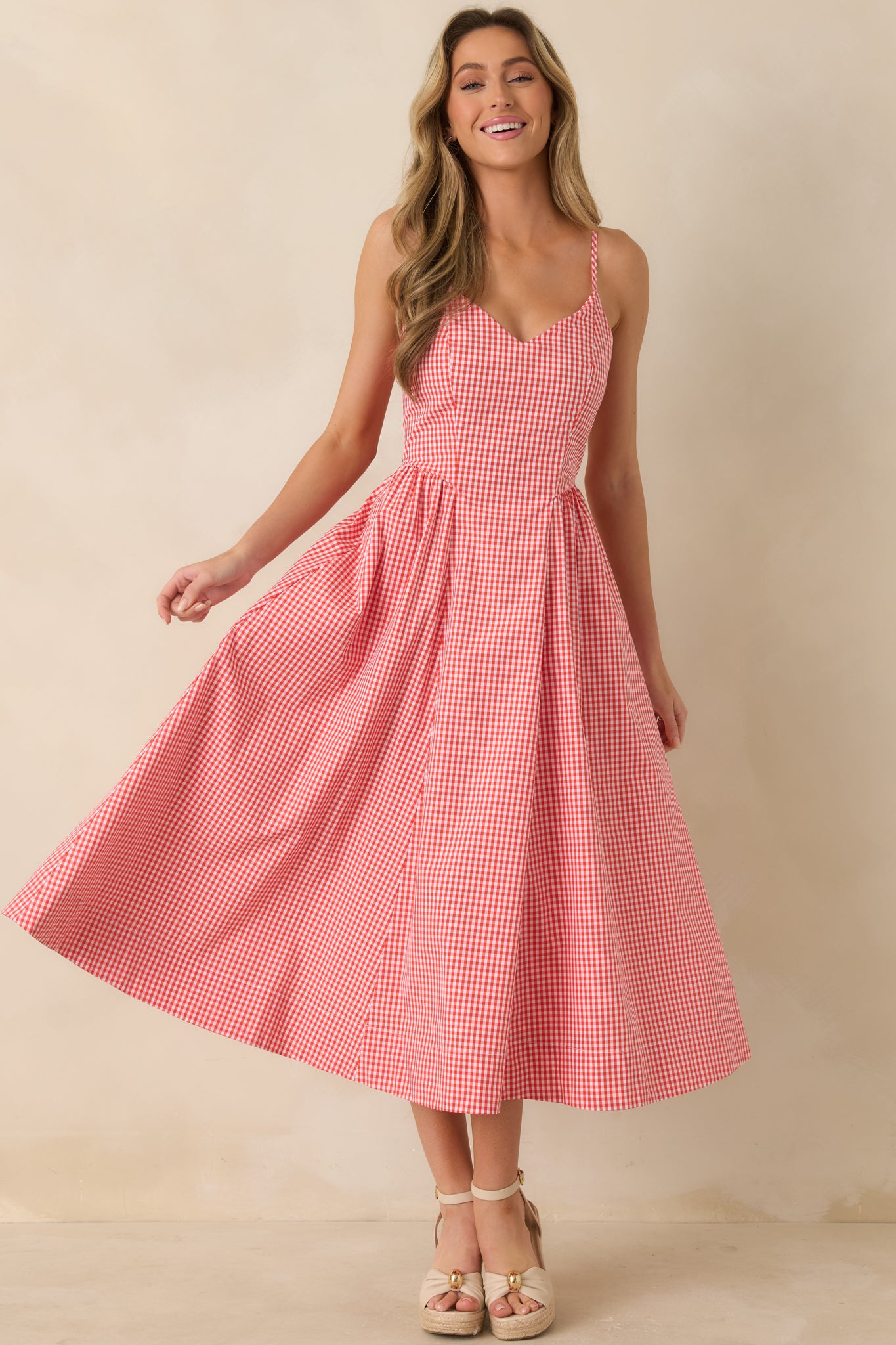 Full view of vertical striped midi dress with delicate straps, airy drape, and softly polished silhouette.
