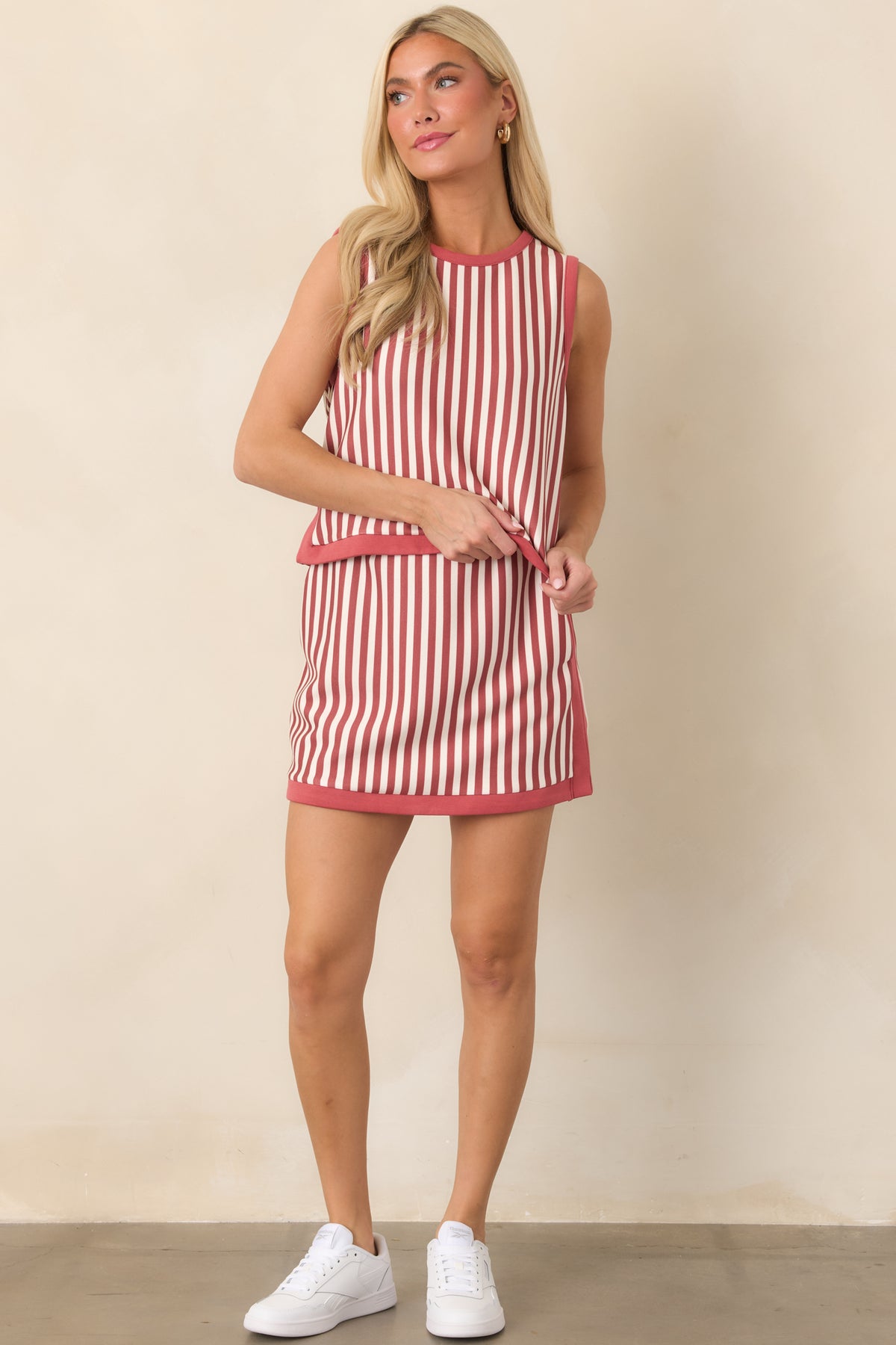 Vertical striped top featuring alternating terracotta and ivory lines, a softly rounded neckline, and an easy cropped shape.