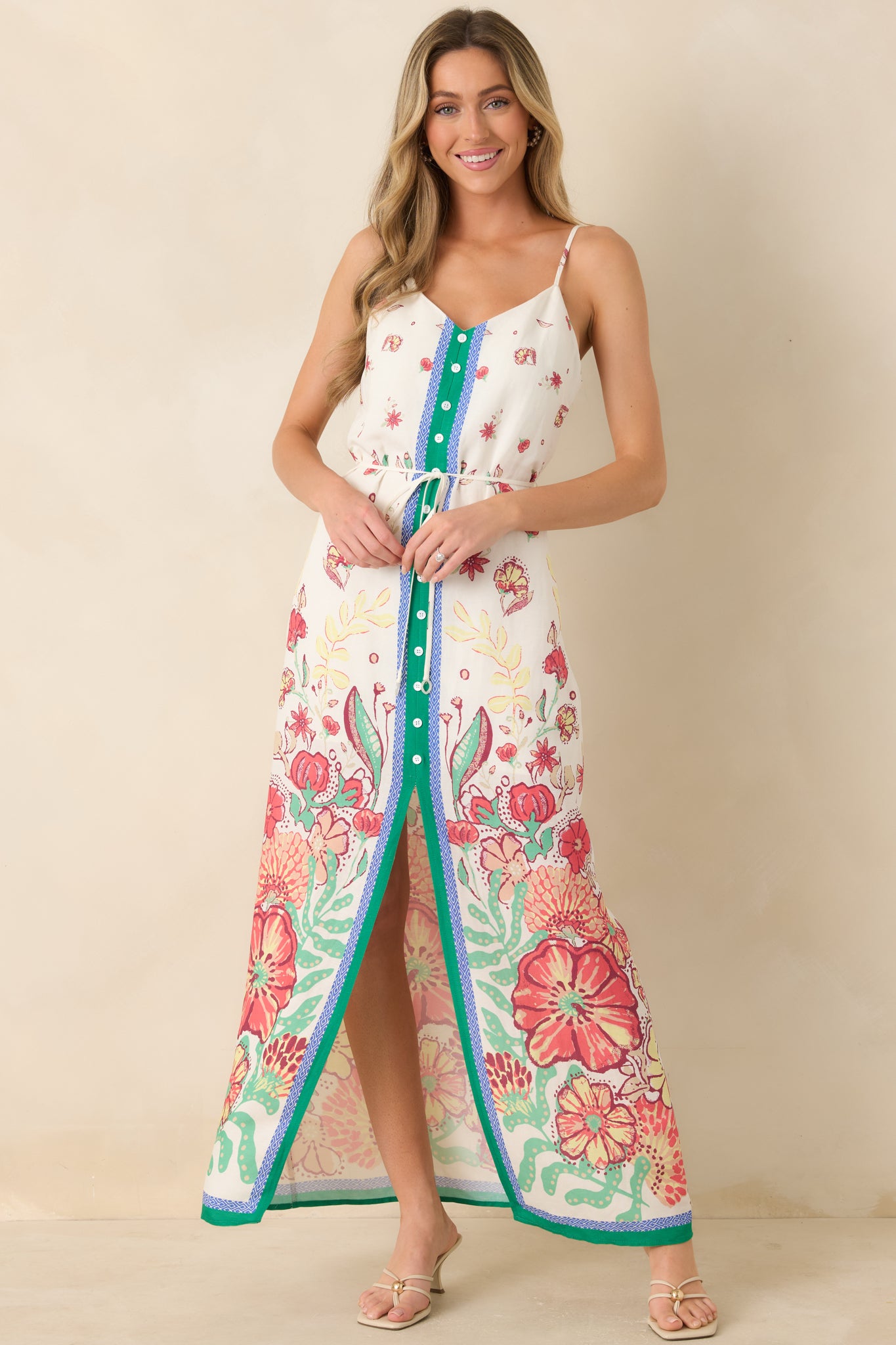 Vibrant floral dress featuring V-neckline, adjustable straps, and defined waist tie.