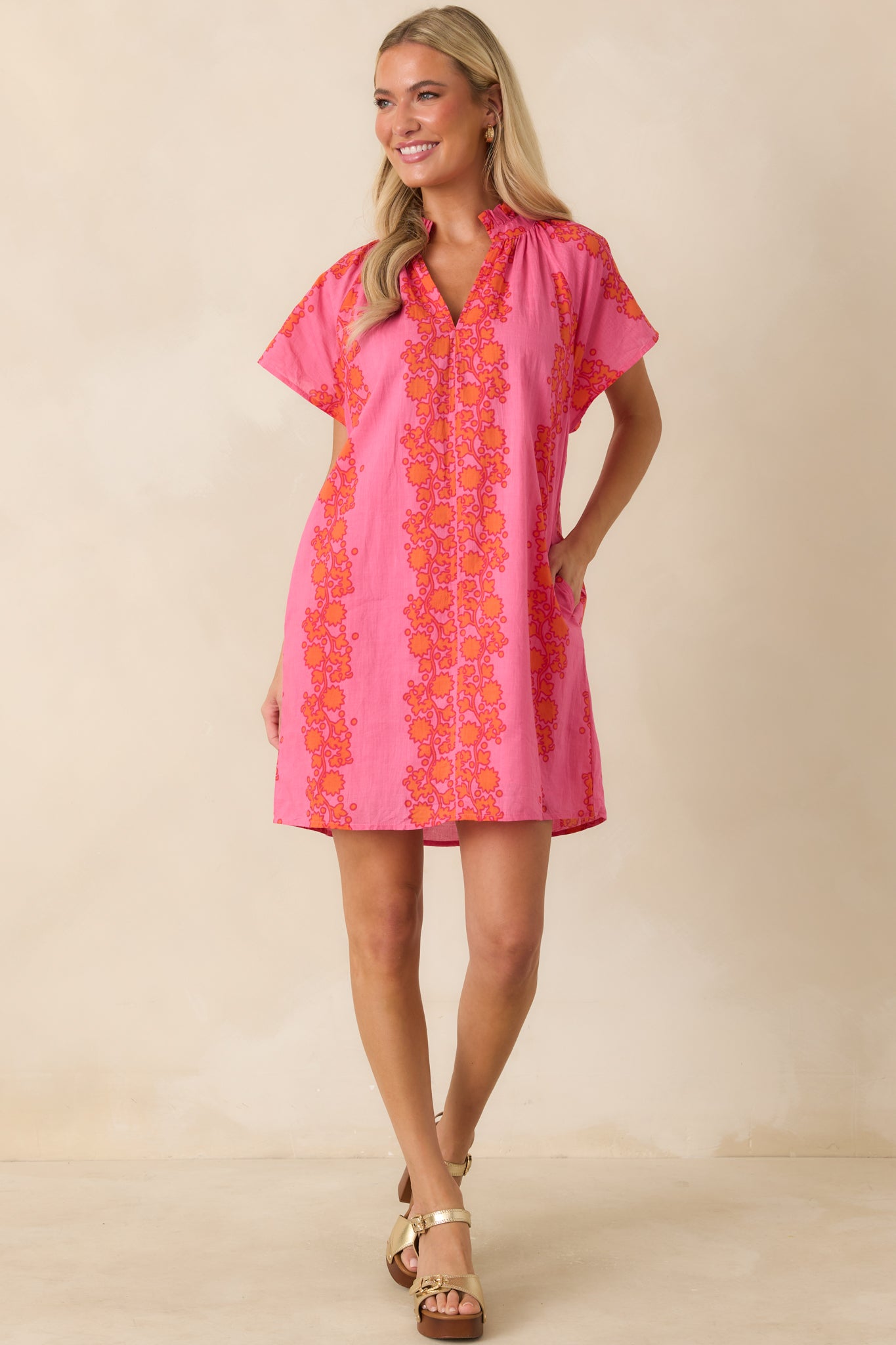 Vibrant floral print mini dress with a split neckline, breezy sleeves, and easy relaxed fit.