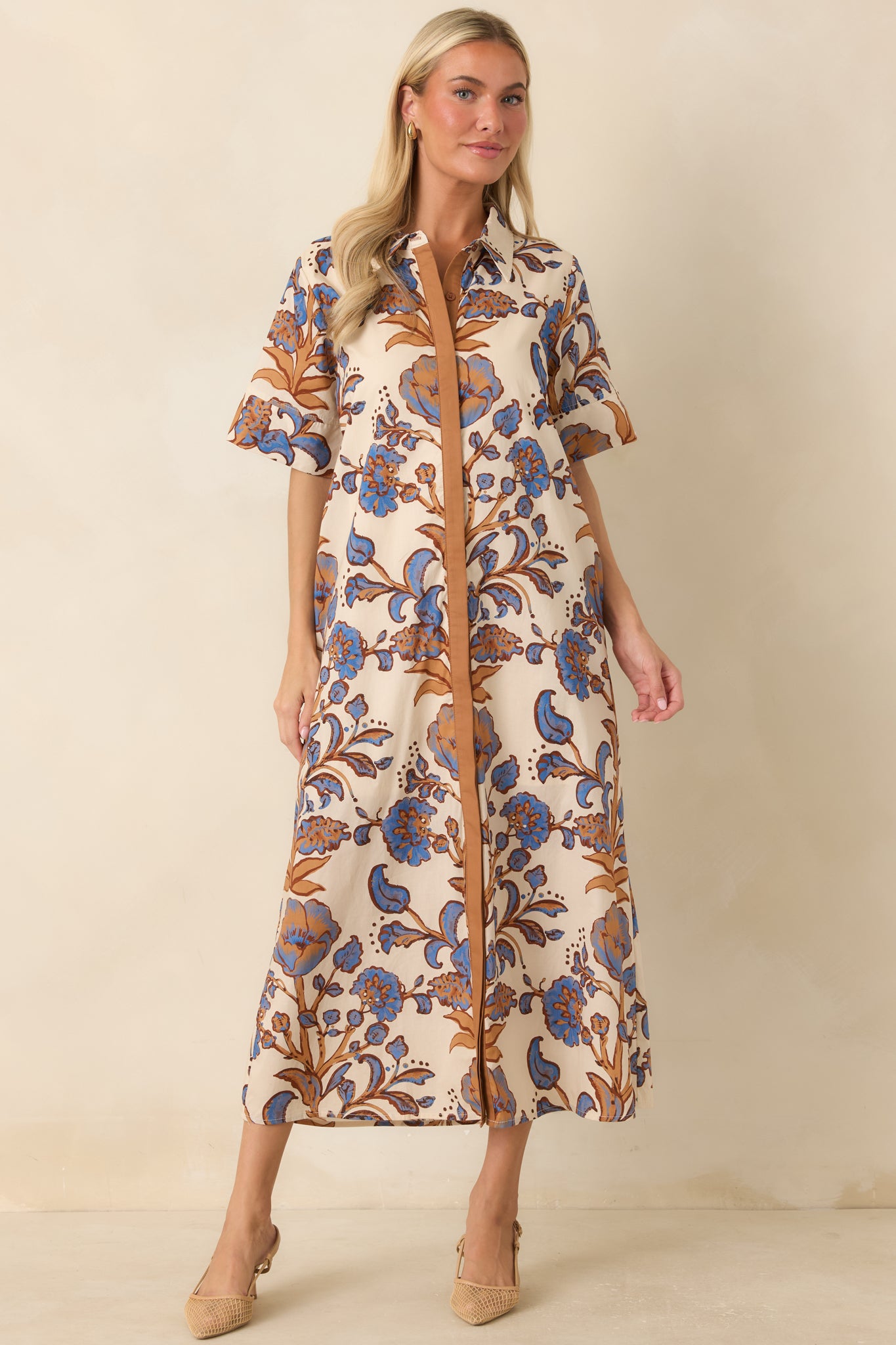 Vibrant floral shirt dress designed with a colorful botanical print, relaxed fit, and practical side pockets.
