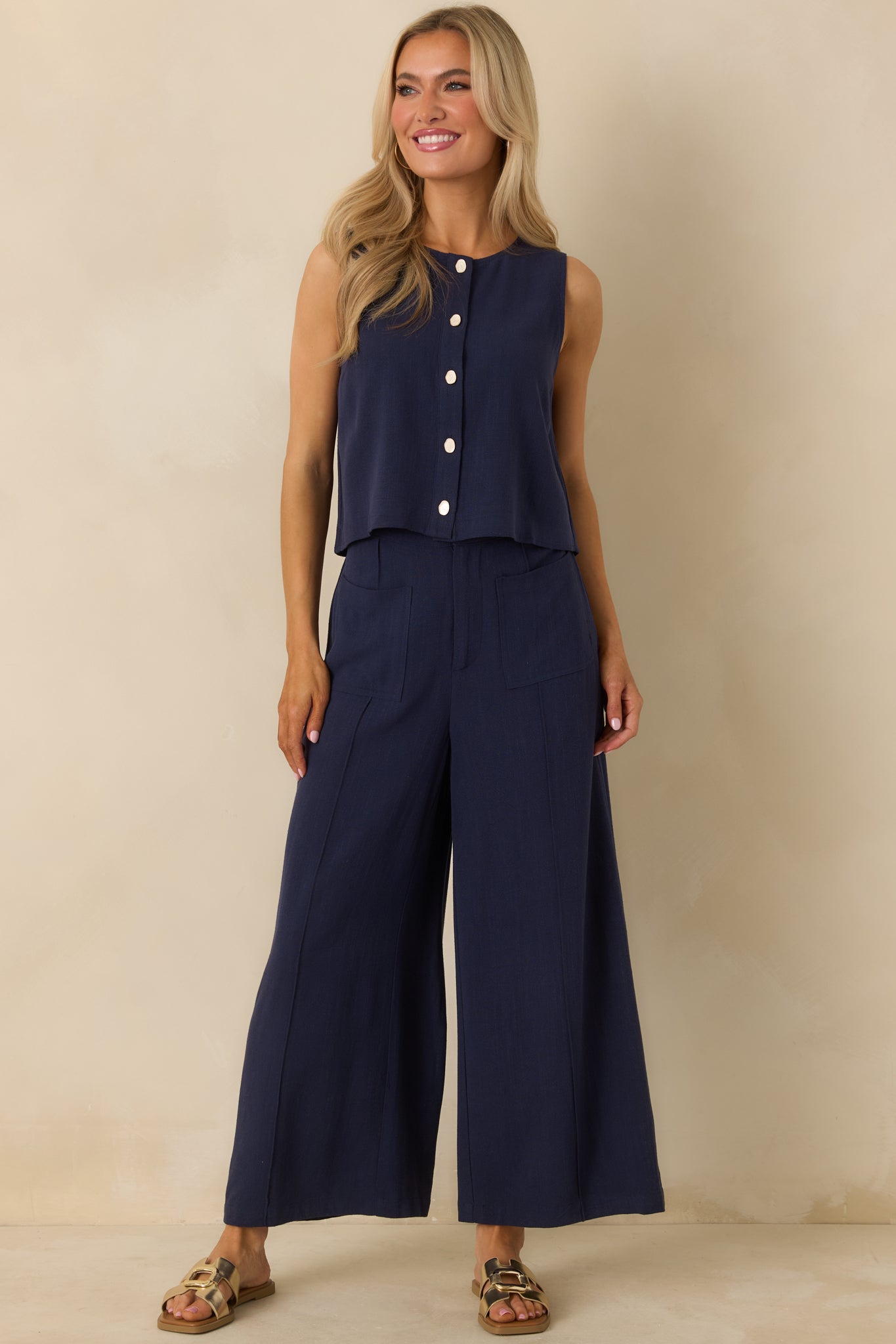 Front-facing full-length view emphasizing the refined shape and lightweight construction of the navy button-up top.