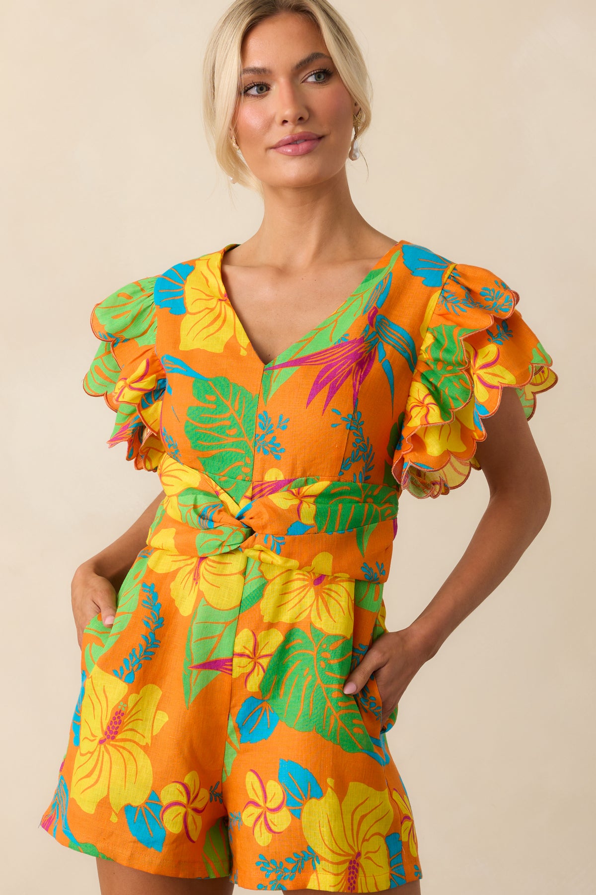 Midsection view of the romper focusing on the faux belt twist detail and functional side pockets.