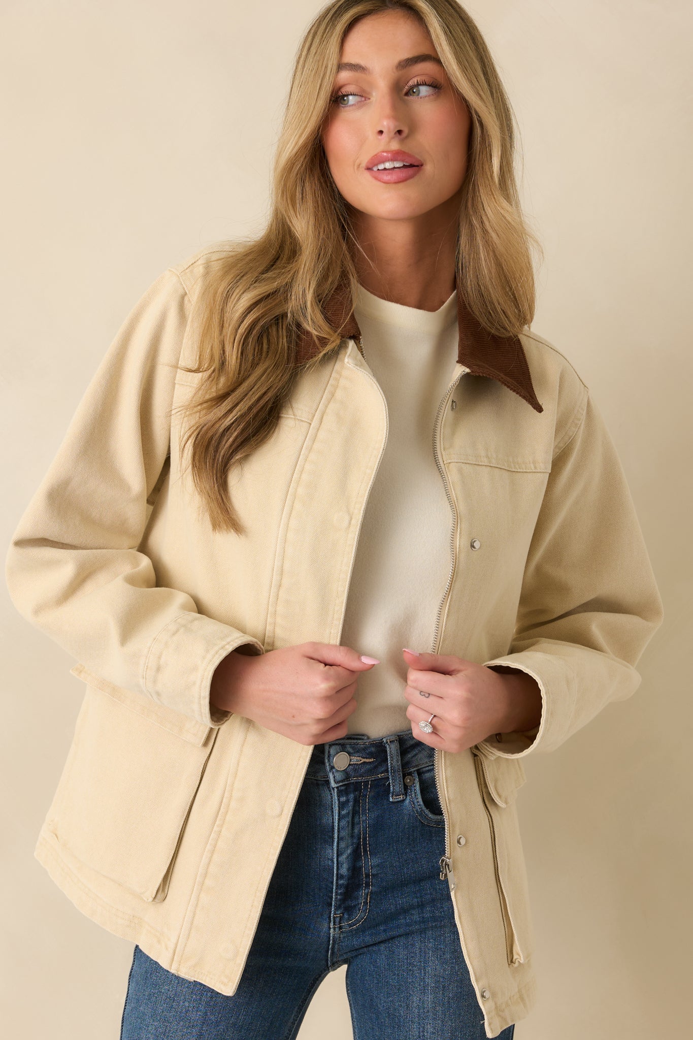 View emphasizing the zip-and-snap closure and the jacket’s understated utility design.