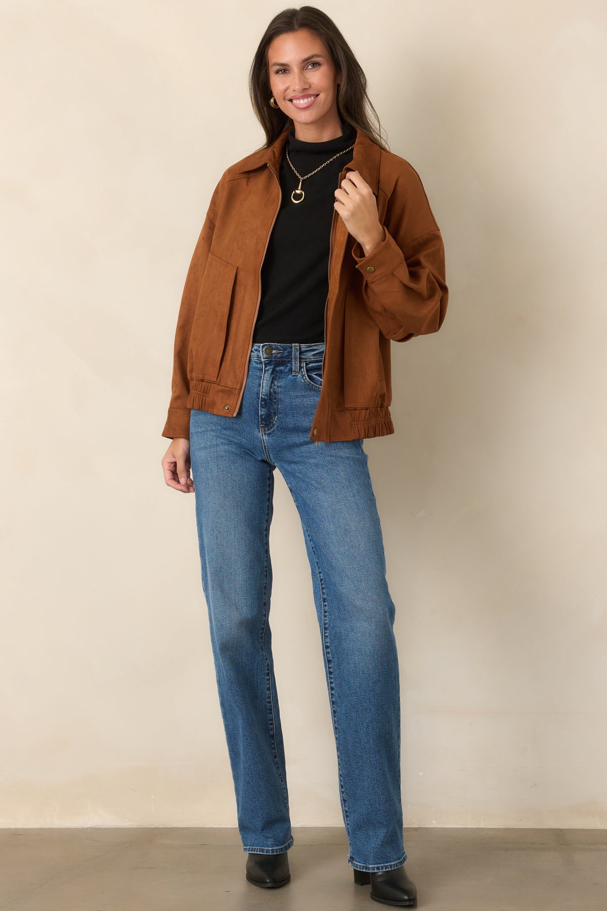 Vintage-inspired cognac faux suede jacket with a zip front, front pockets, and softly gathered bomber hem.