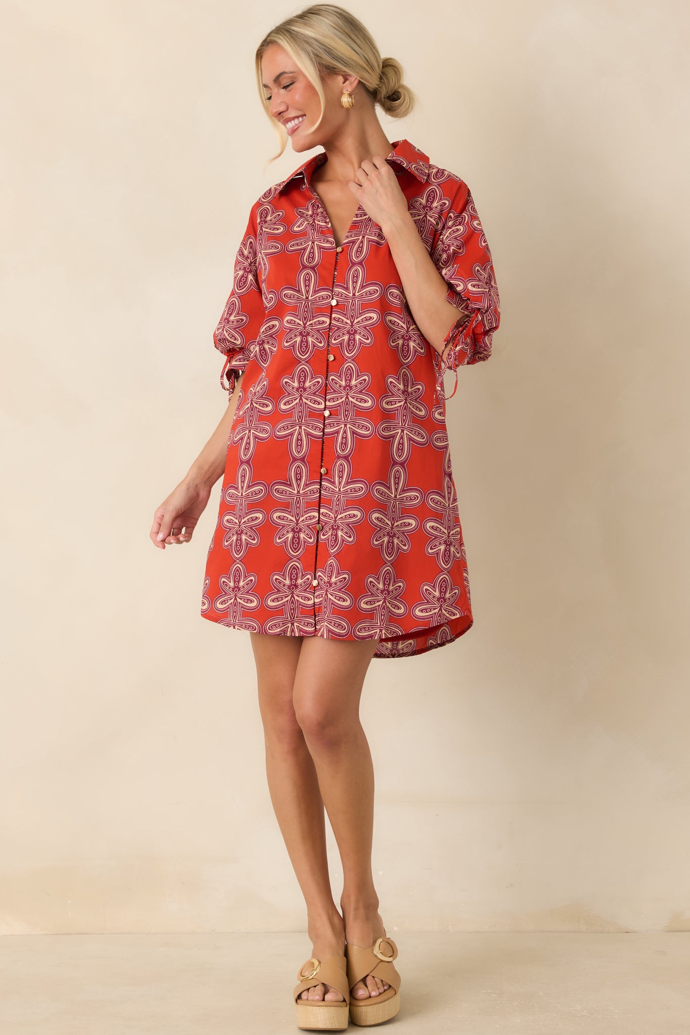 Vintage-inspired cotton mini dress with a classic collar, functional button front, tie-detail puff sleeves, and side pockets.
