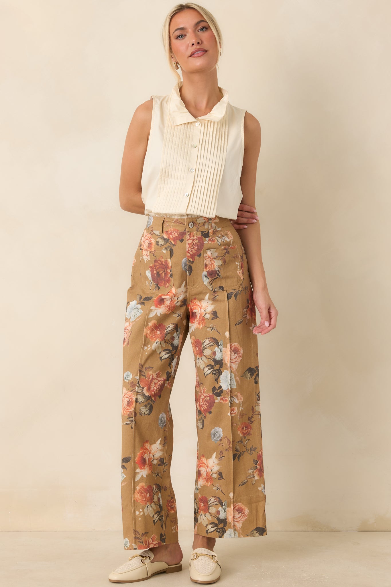 Vintage-inspired floral pants crafted from woven cotton with a tailored fit, wide legs, and a warm camel background.
