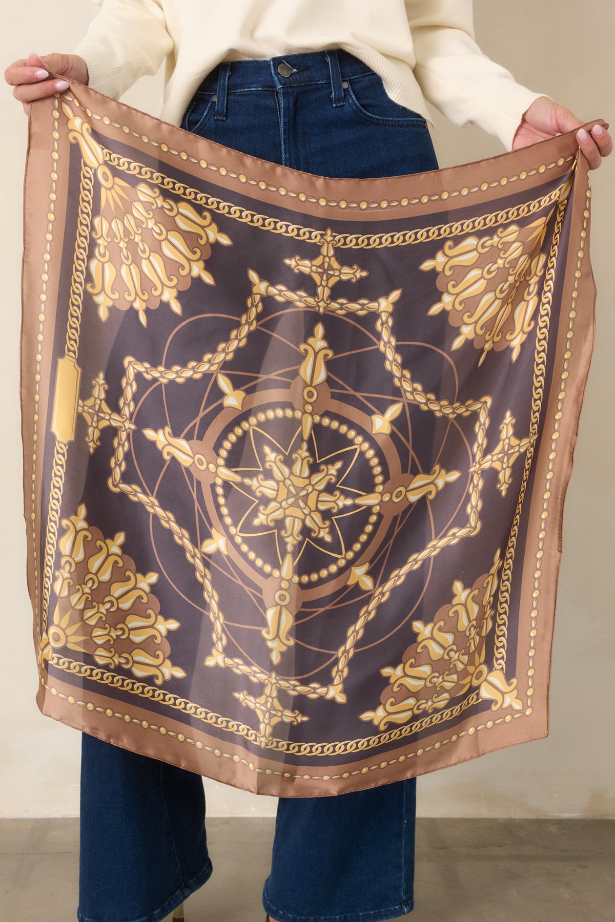 Vintage-inspired scarf showcasing gold chain motifs and decorative medallions framed by a camel border.