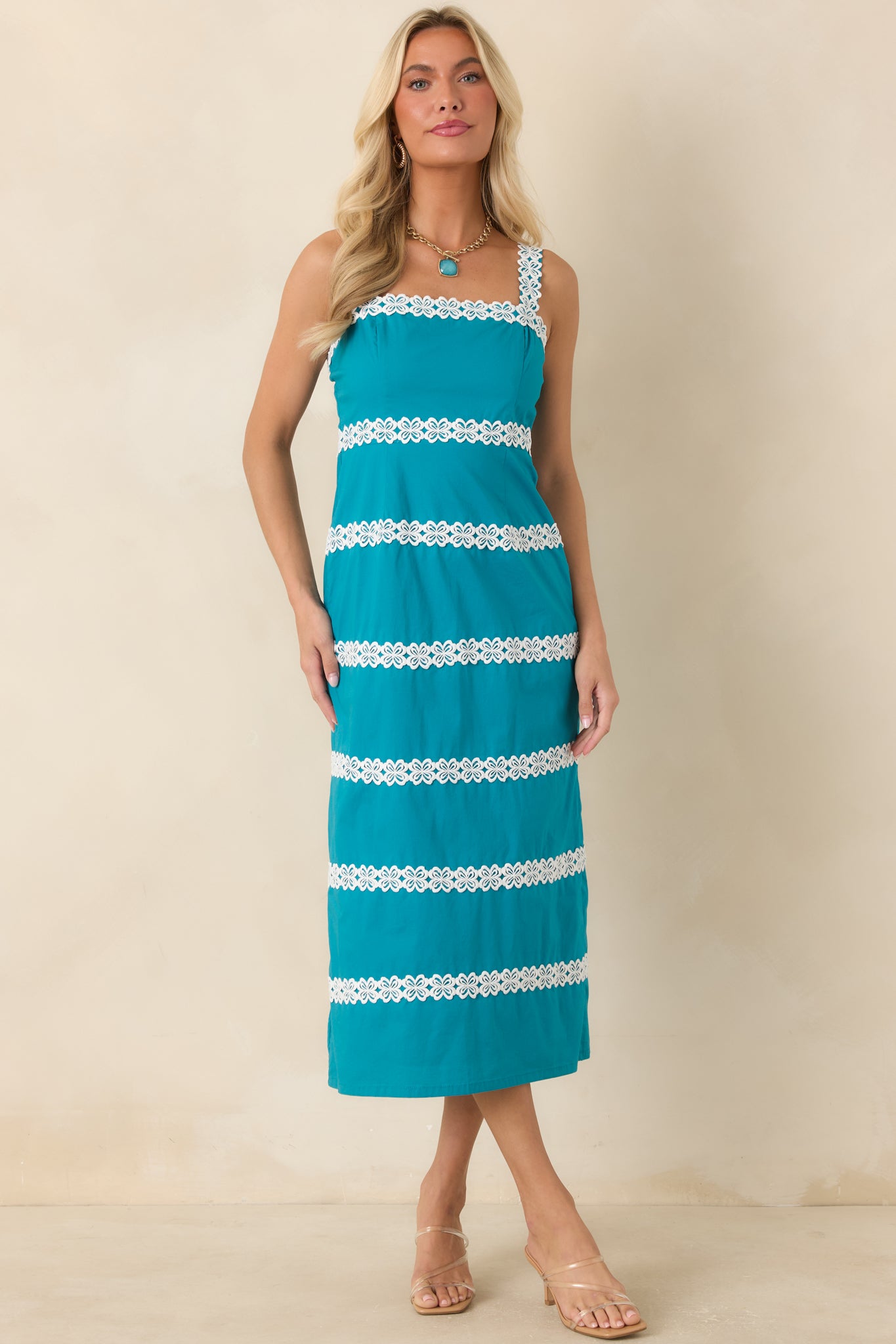 Vintage-inspired dress with wide shoulder straps, contrast lace trim, and a streamlined midi shape.