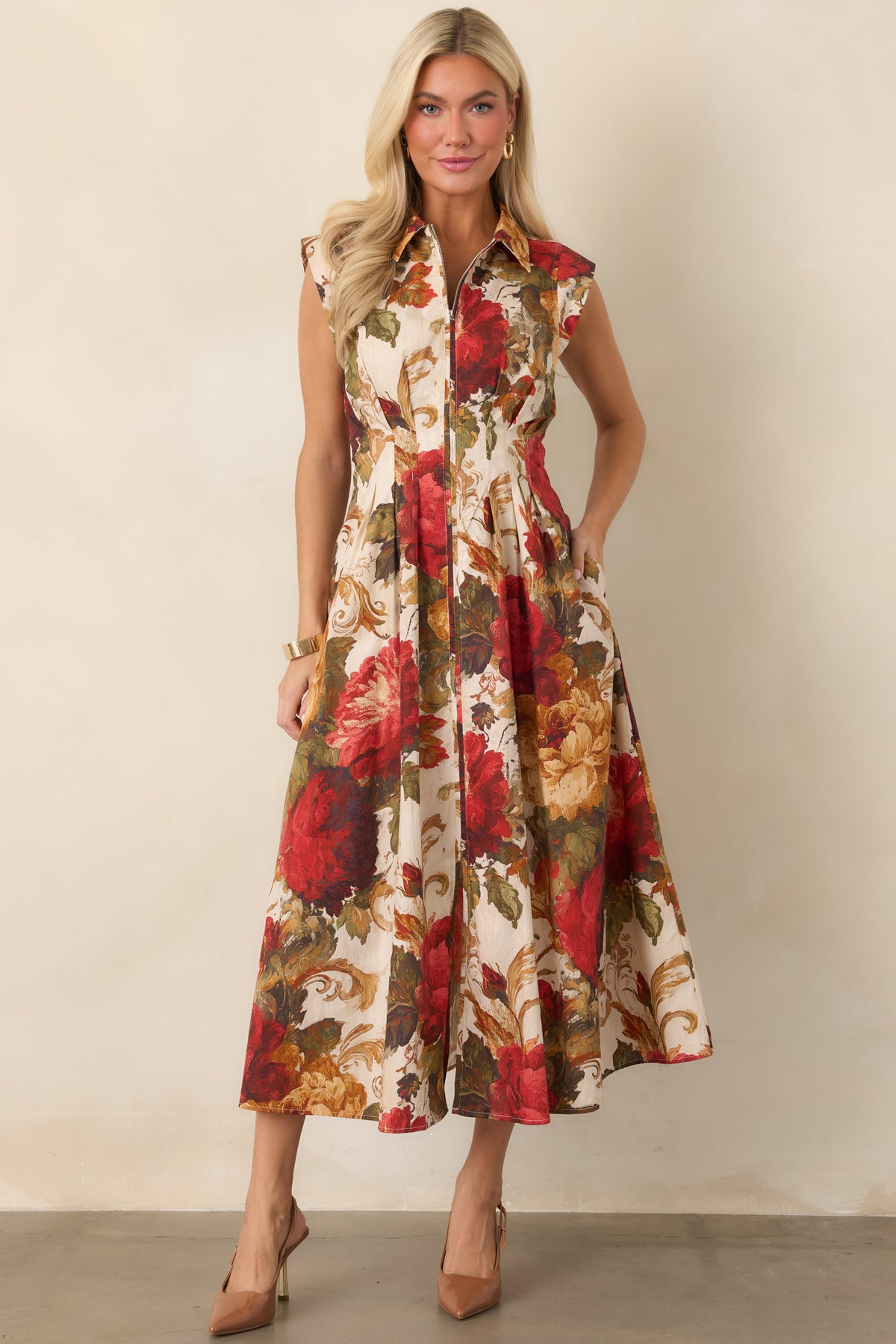 Vintage-inspired floral dress with a pointed collar and structured cap sleeves.