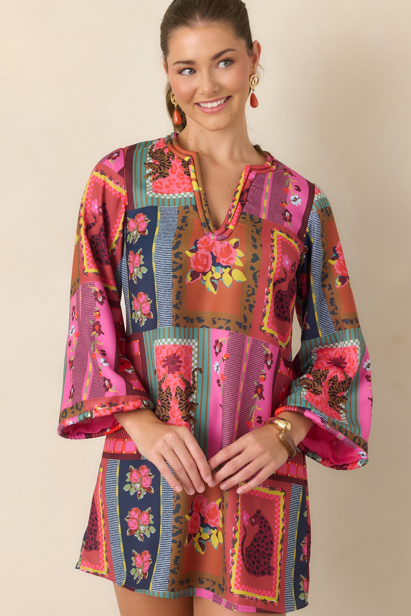 Vintage Vignette mini dress detail highlighting the colorful print, soft V-neckline, and matching corded trim framing the neckline and sleeves.