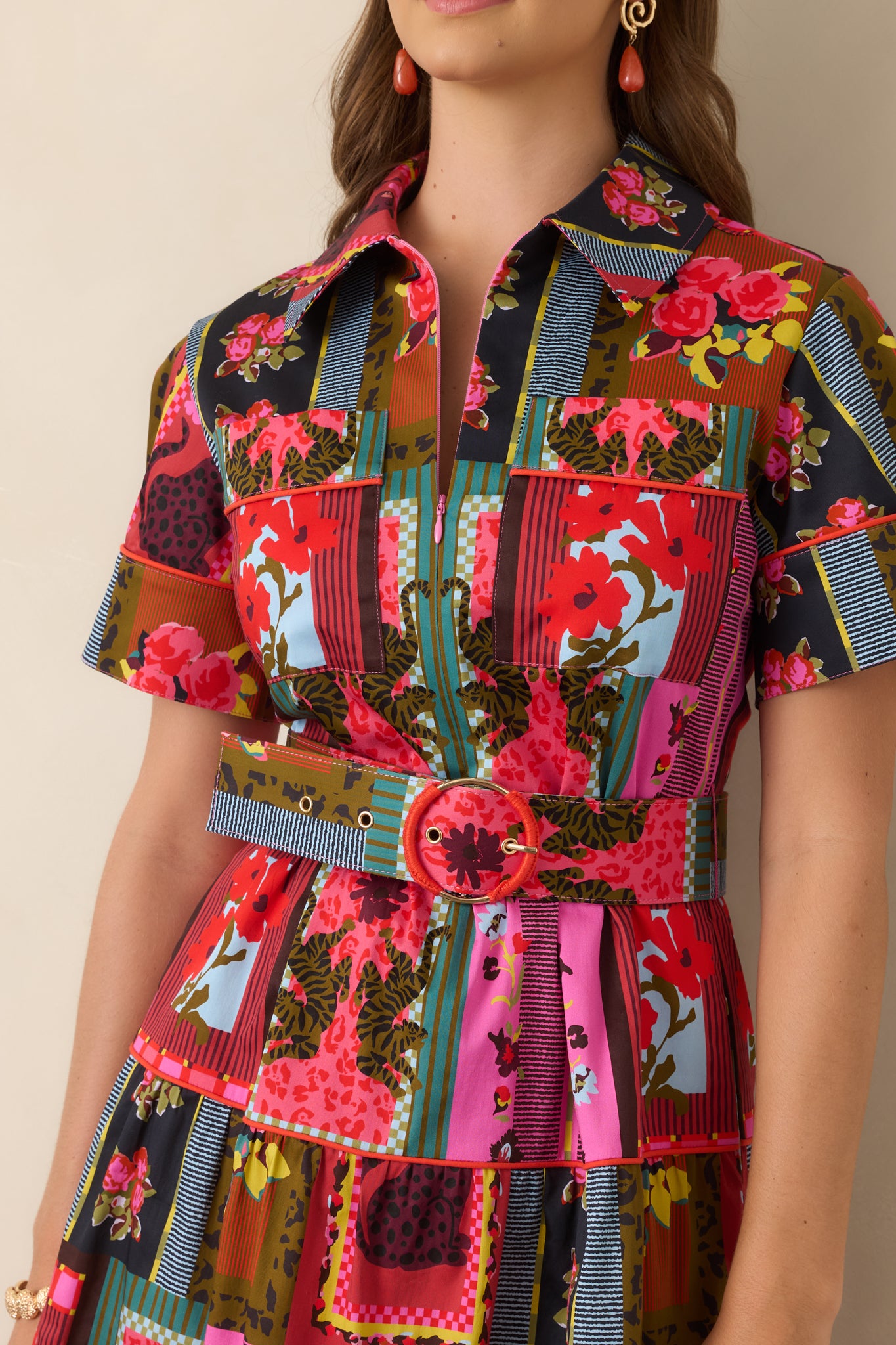 Close-up of the Vintage Vignette dress highlighting its intricate floral, striped, and framed motifs, contrast piping, detailed sleeve cuff, and stretch cotton-blend texture.