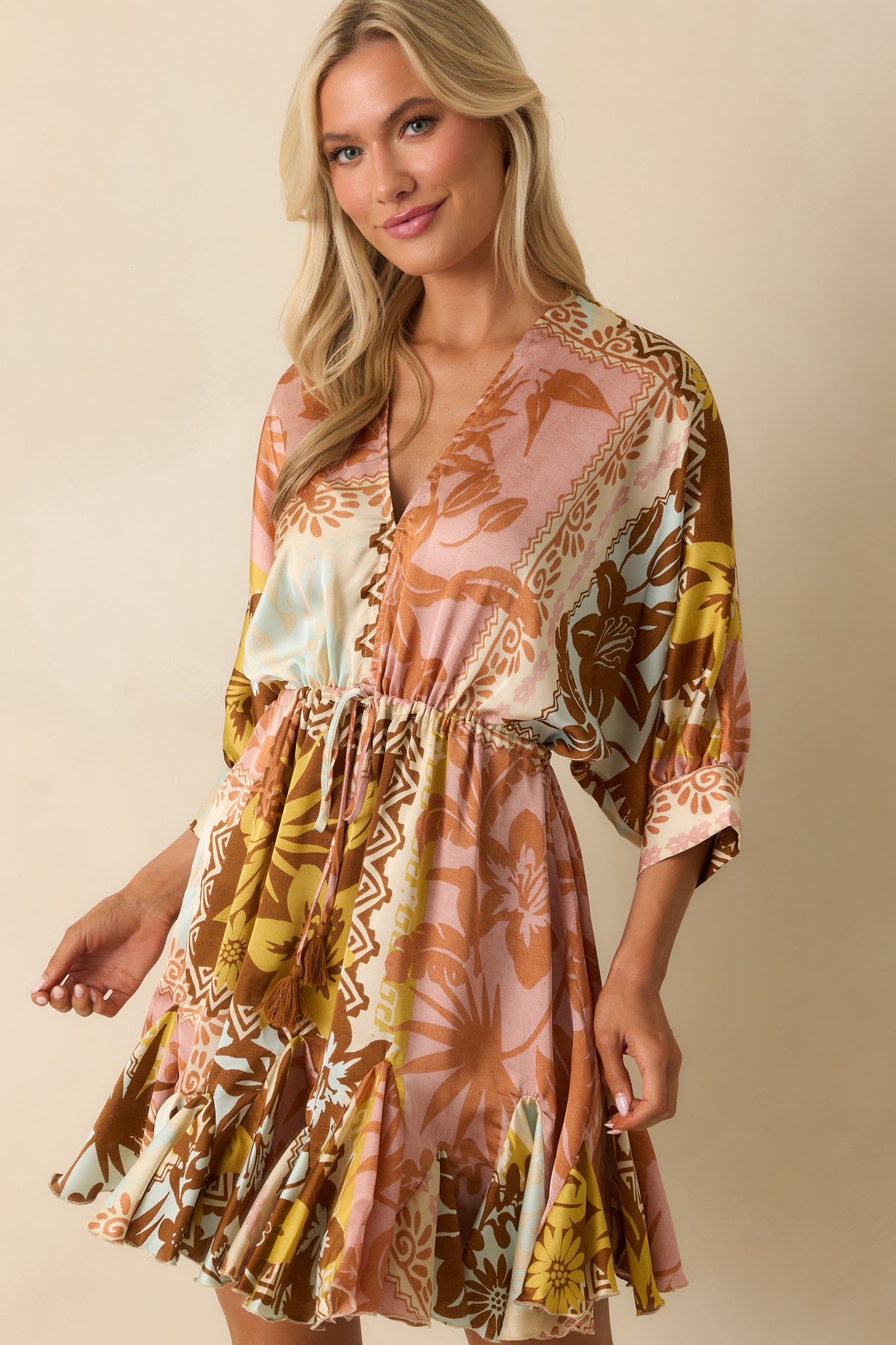 Focus on the waist tie and fabric texture of the pink coral mini dress.