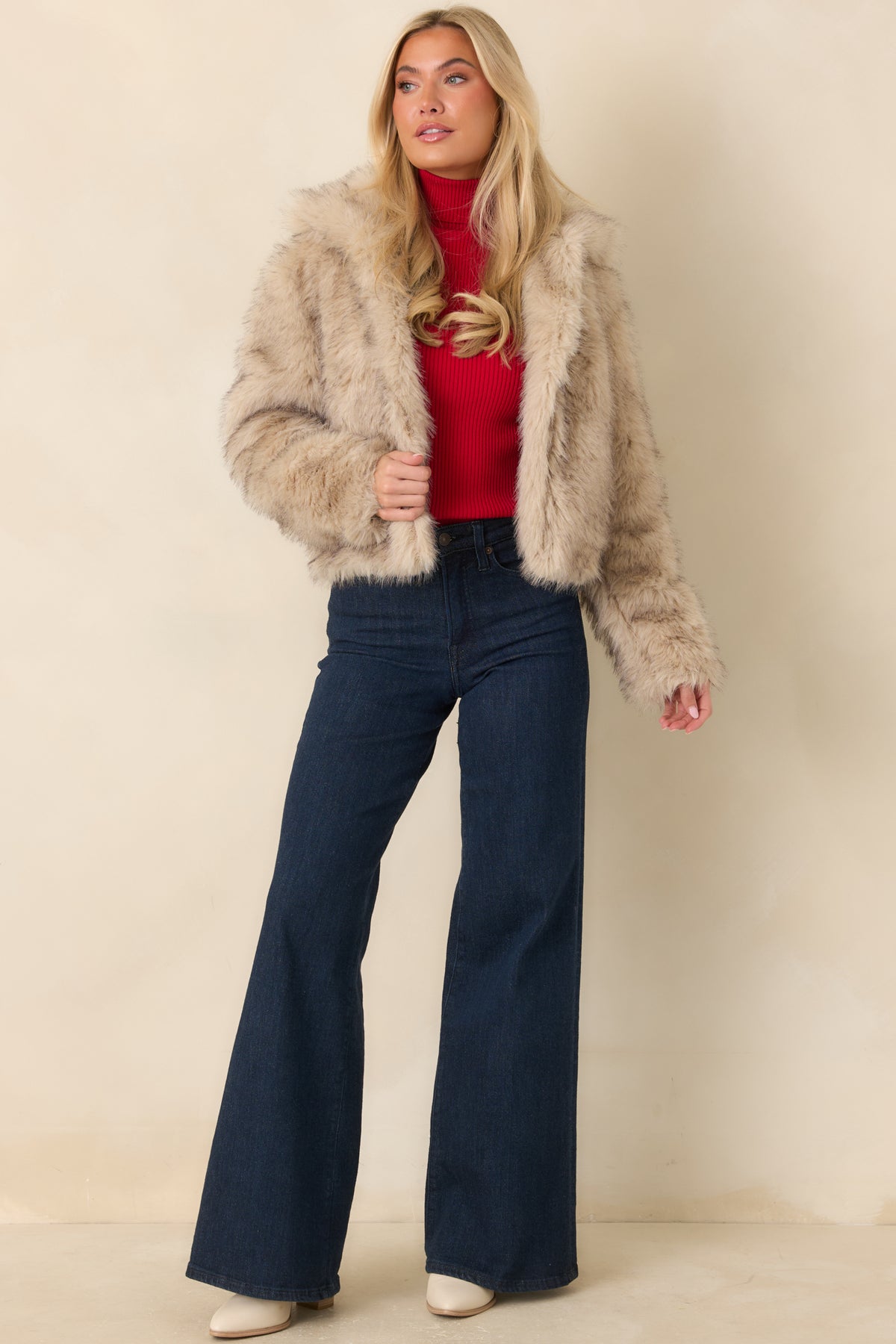 Warm beige faux fur jacket with voluminous full-length sleeves and a relaxed cropped fit.