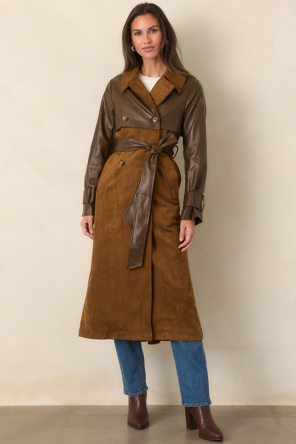 Warm caramel suede-look fabric forms the long coat body, finished with brown faux leather sleeves and a tie belt.