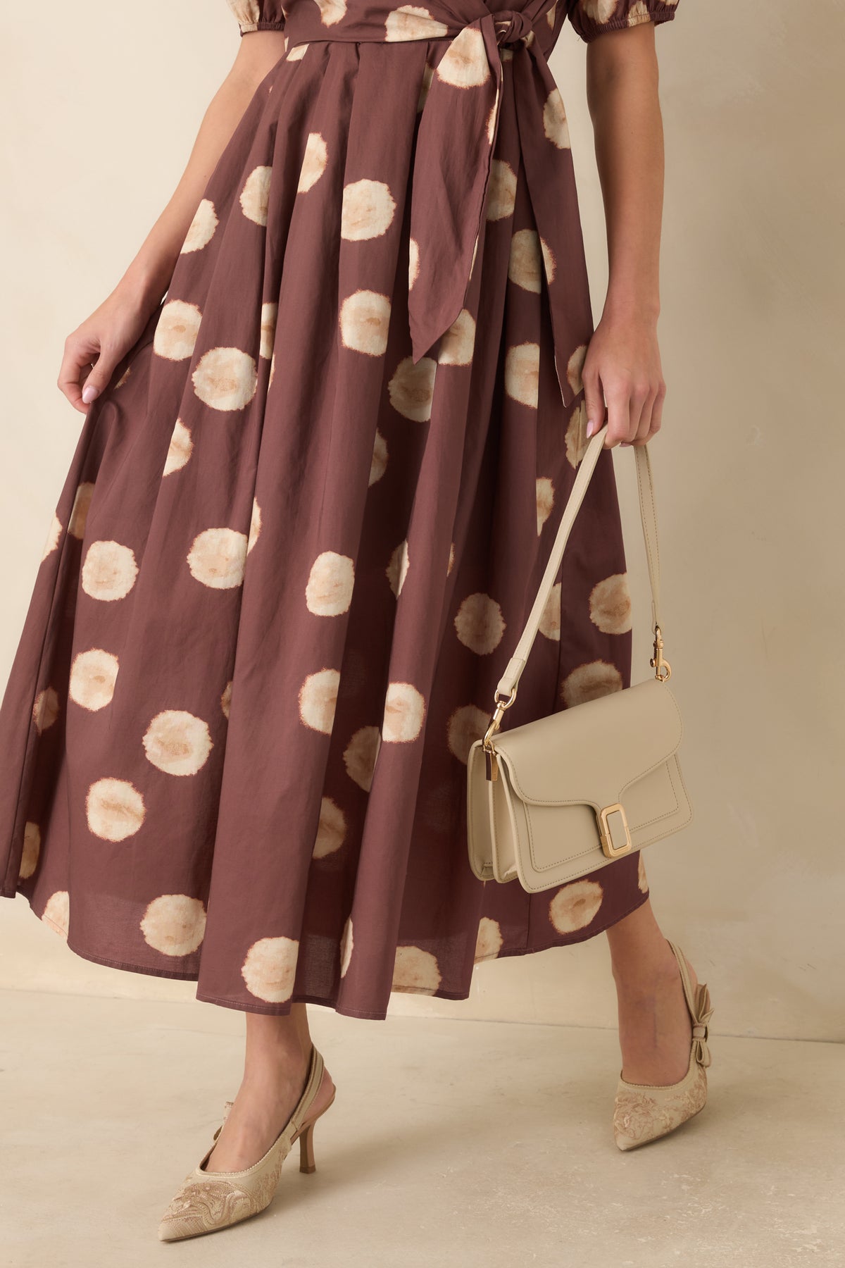 Warm earthy midi dress highlighting the softly blurred dot print across the flowing A-line skirt.