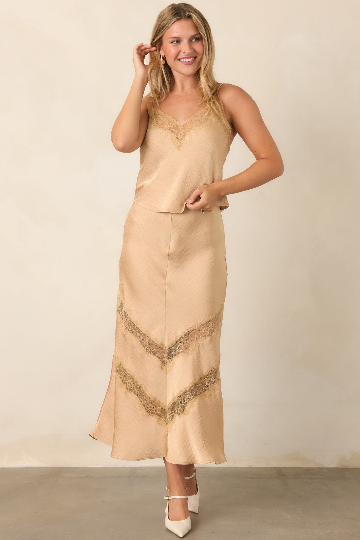 Warm tan skirt with a fitted waist, subtle crinkled texture, and easy drape through the body.