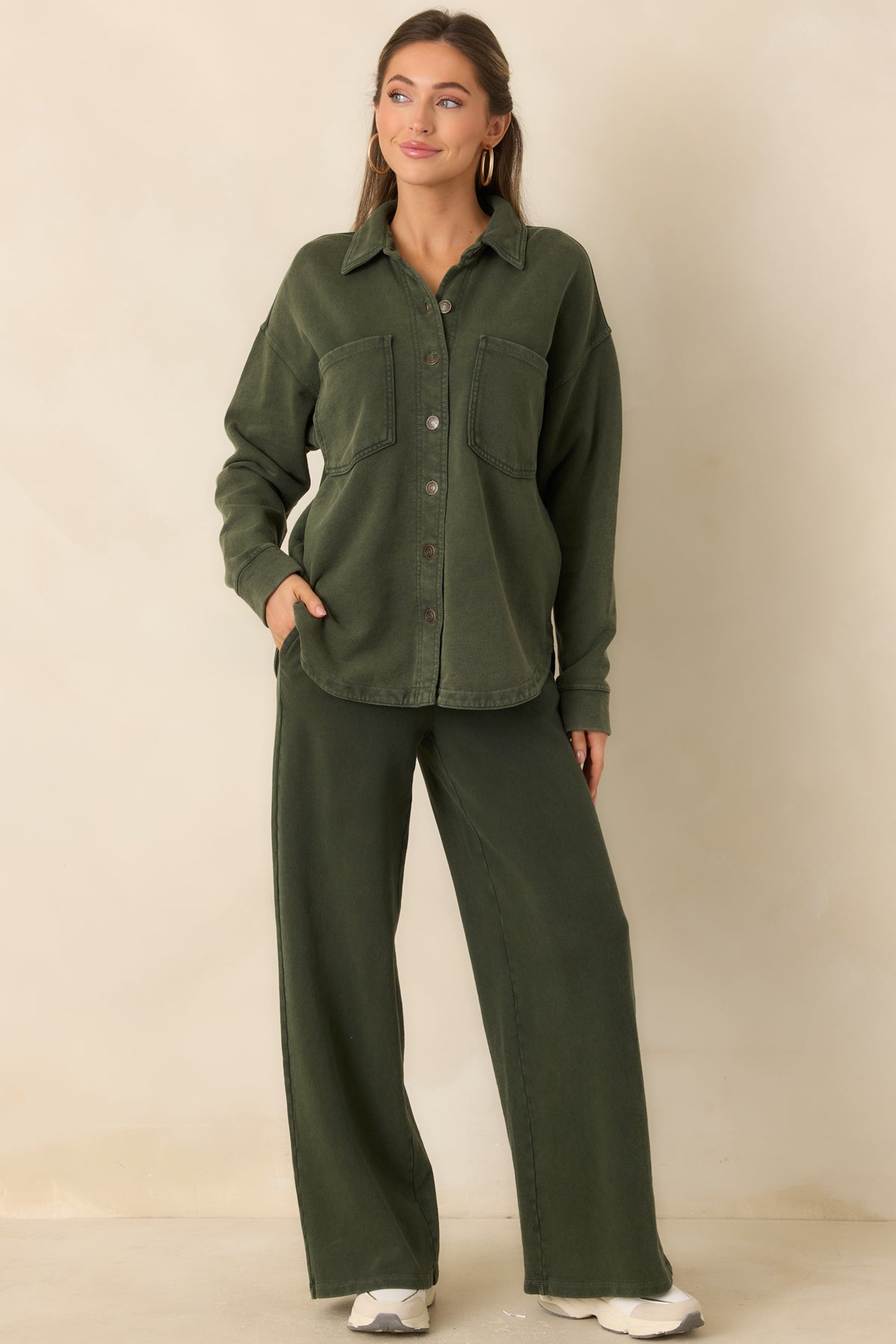 Washed olive green cotton French terry jacket with a pointed collar, button front, and oversized chest pockets.
