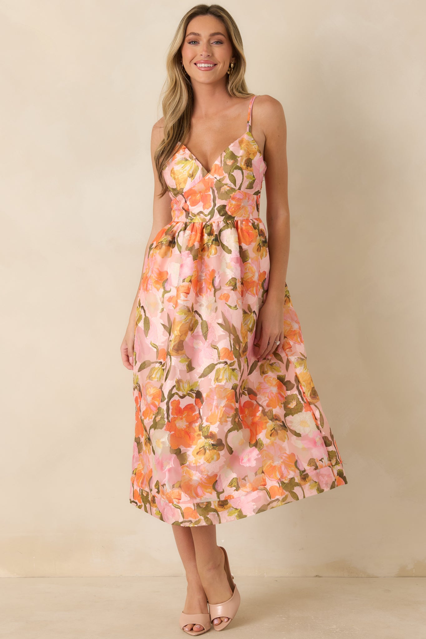 Watercolor-inspired floral midi dress showcasing a smocked back fit, feminine surplice bodice, and practical side pockets.