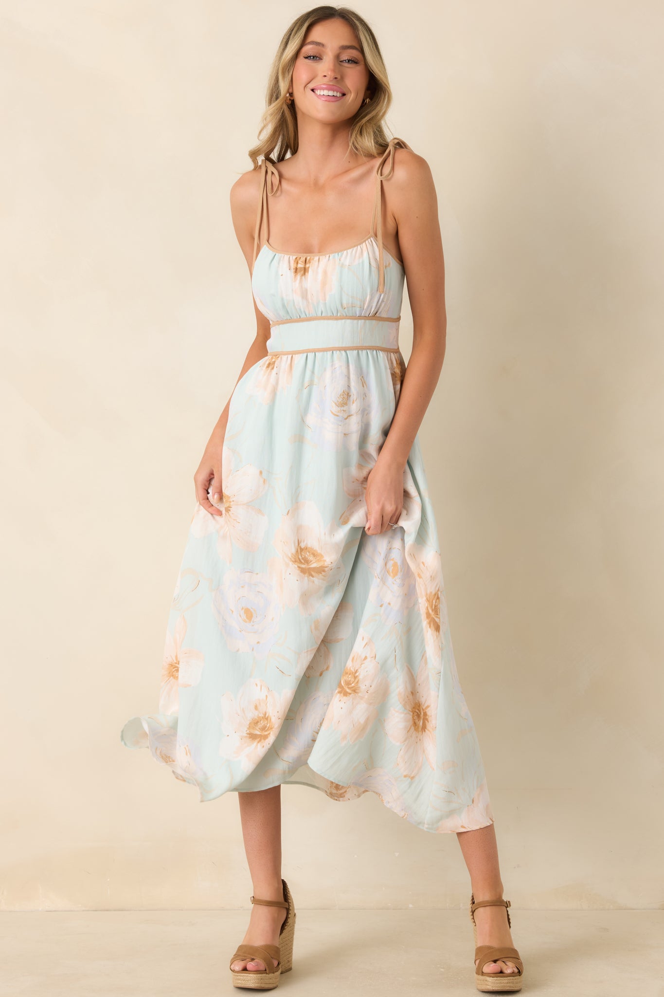 Watercolor floral dress featuring adjustable shoulder ties, a structured bodice, and a romantic mint green palette.
