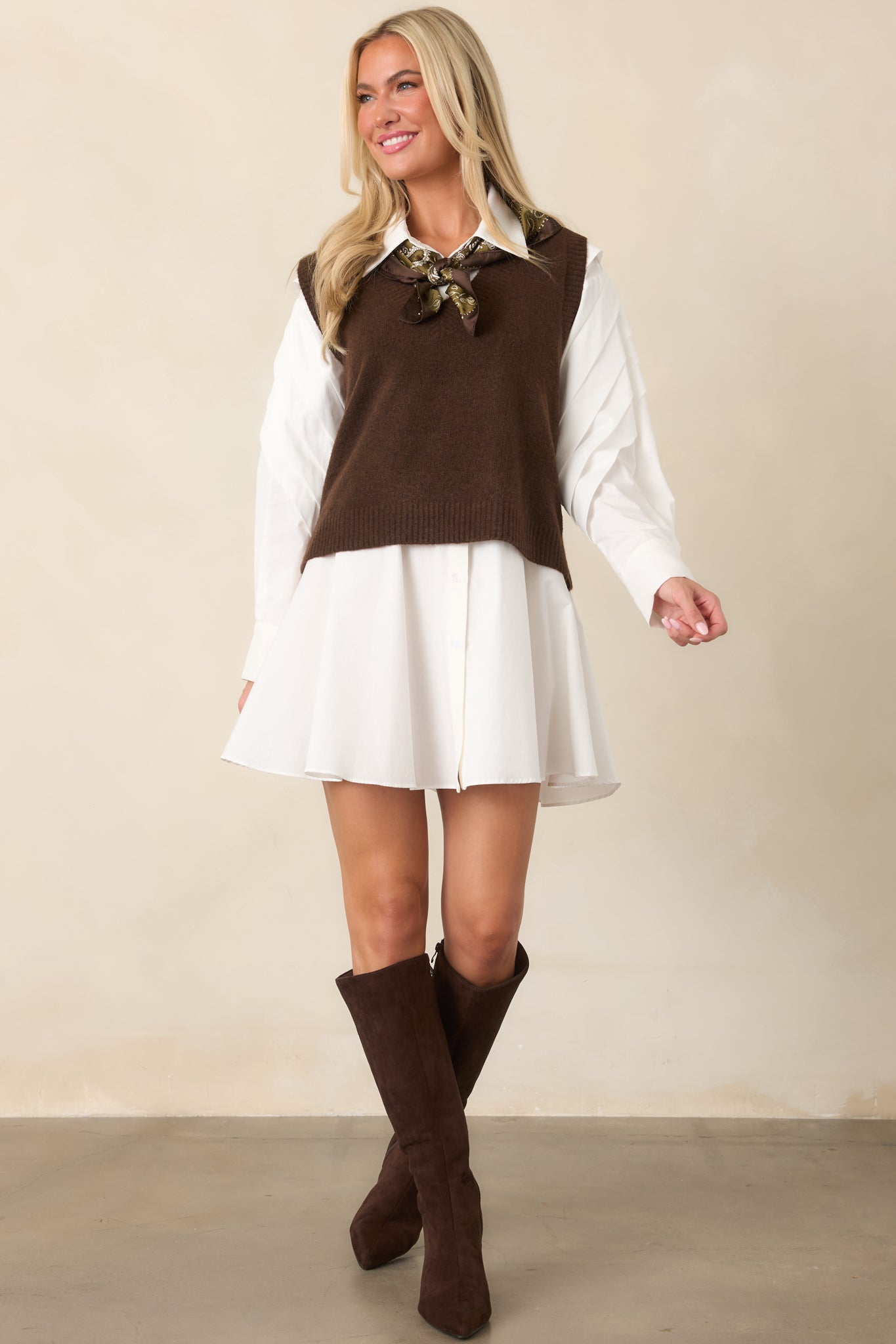 White woven cotton mini dress with a collared neckline, button-front closure, long sleeves with button cuffs, and gently flared skirt.