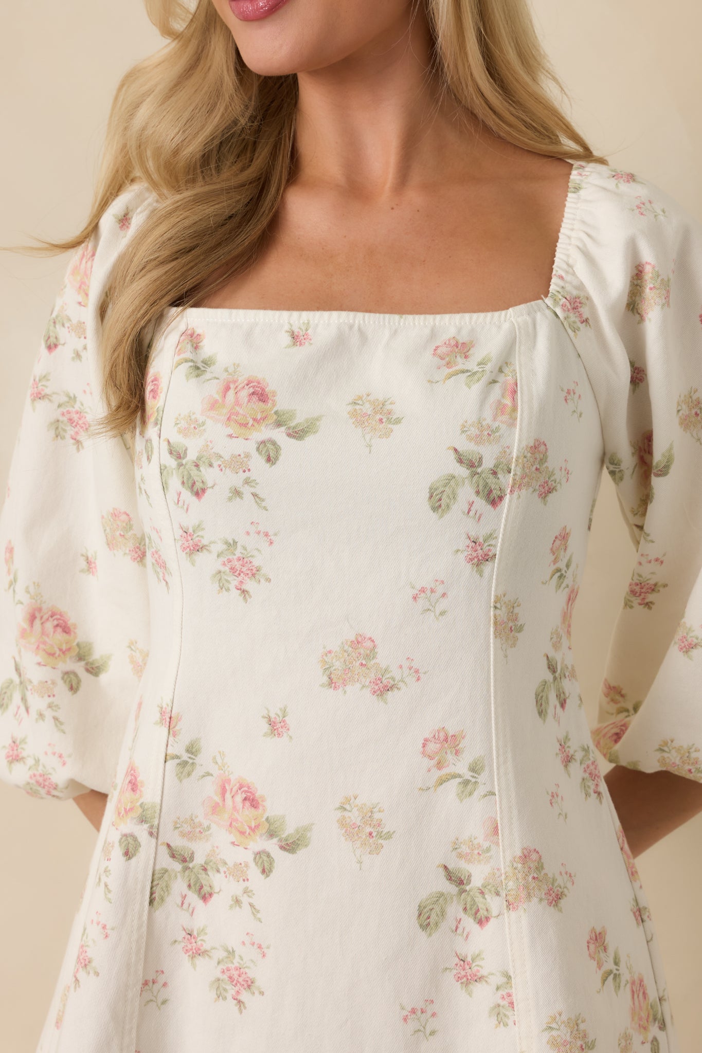 White cotton fabric with multicolor floral print and subtle texture.