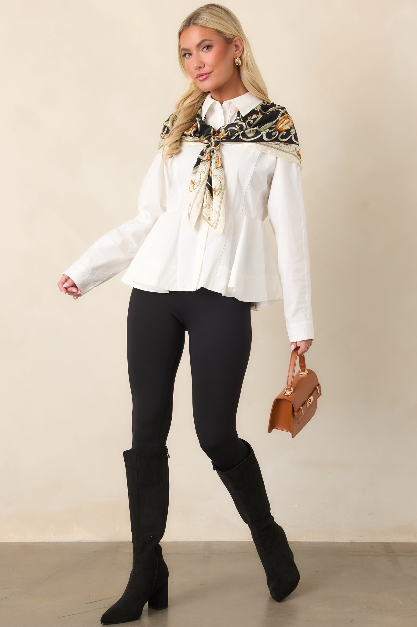 White cotton top with tailored waist seams, a full button closure, and structured peplum shaping.