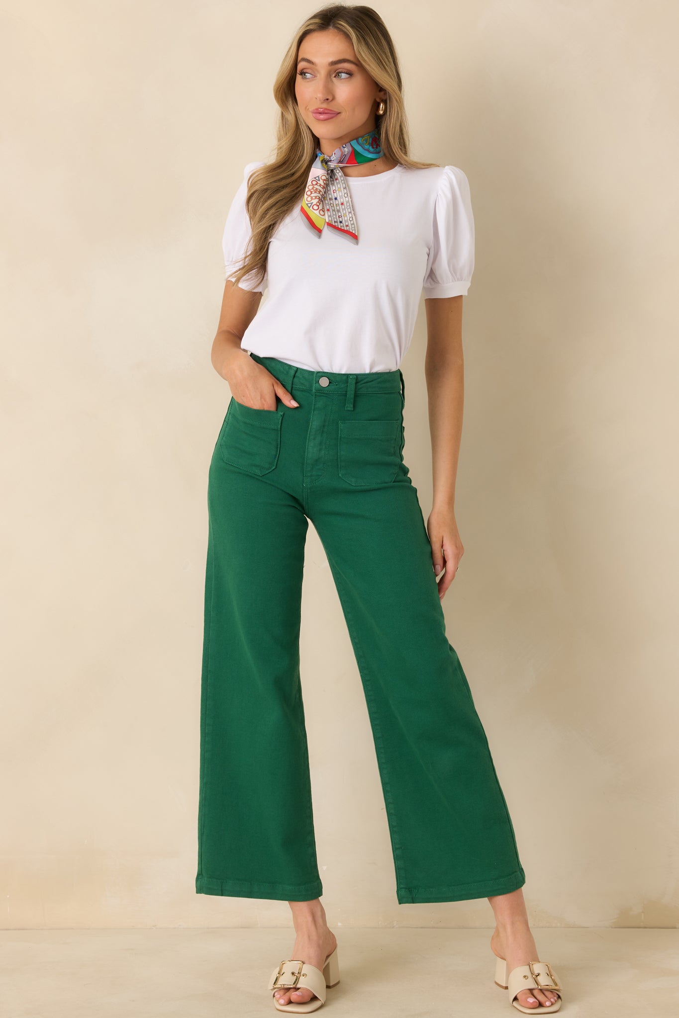 White crew neck top in soft cotton knit, styled with light puff sleeves and a timeless silhouette.