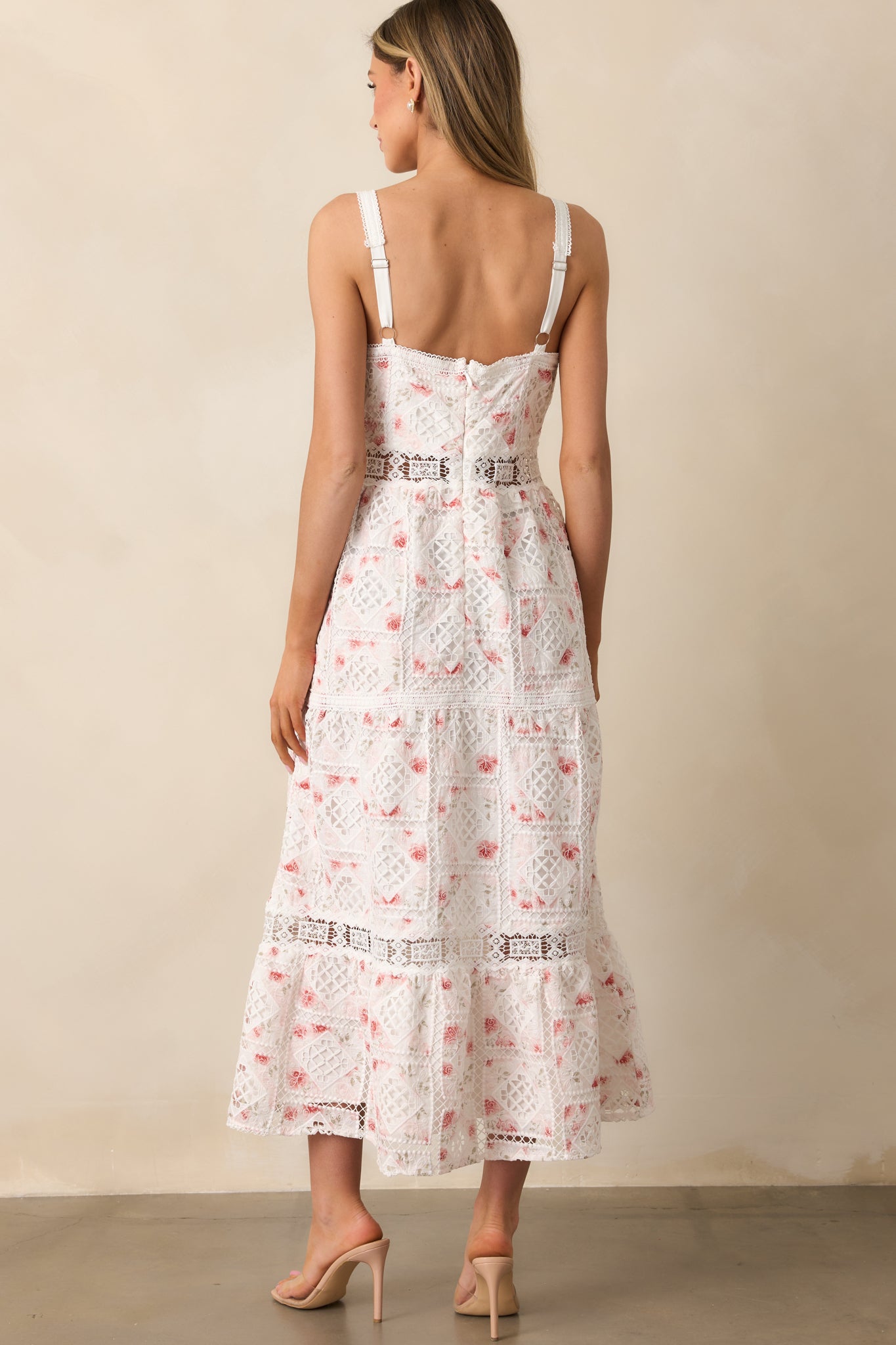 The back of the dress showcasing the tiered skirt, intricate embroidery, and subtle eyelet cutout pattern.