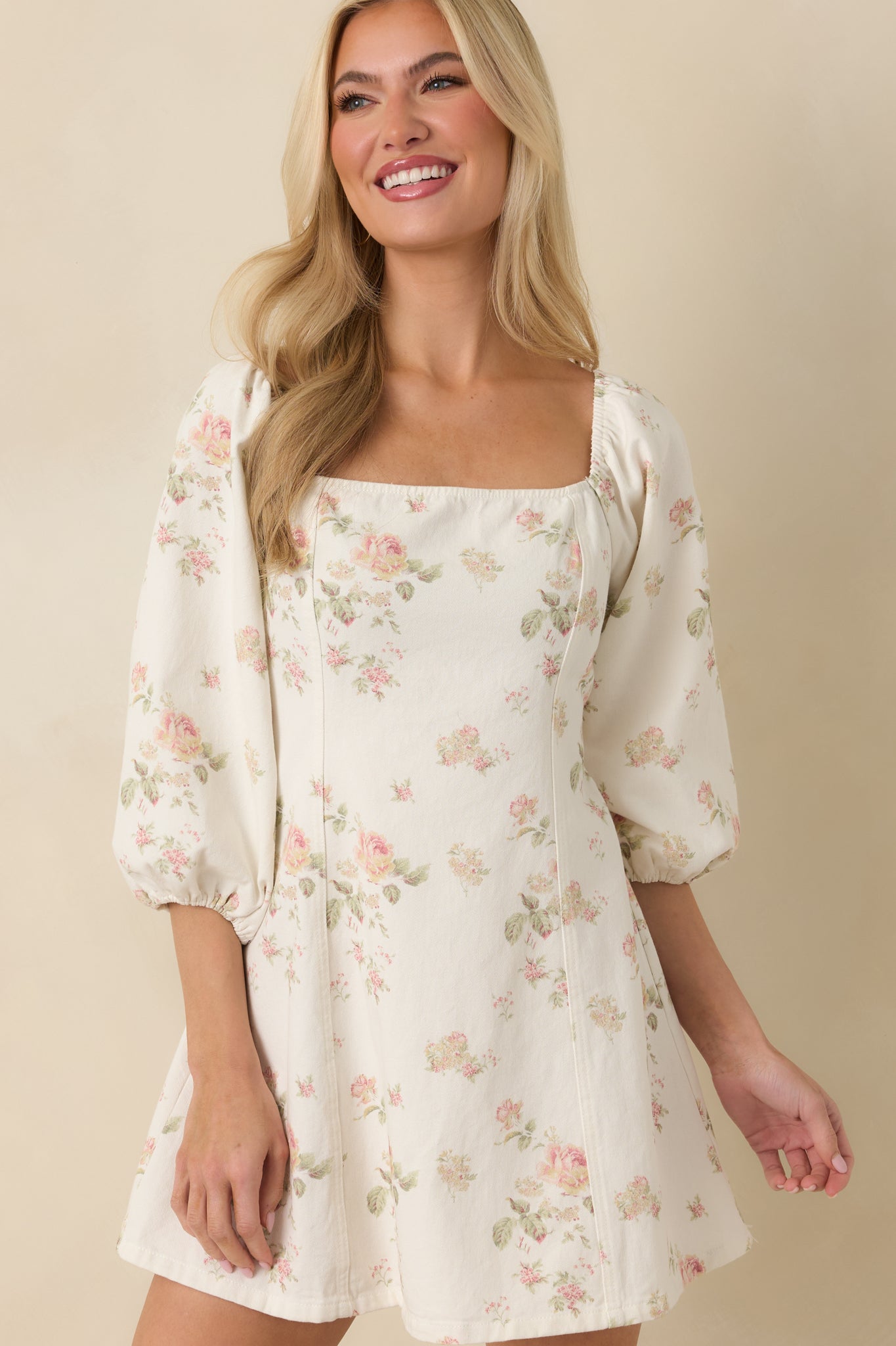 White floral mini dress highlighting the fitted bodice and tailored shaping.