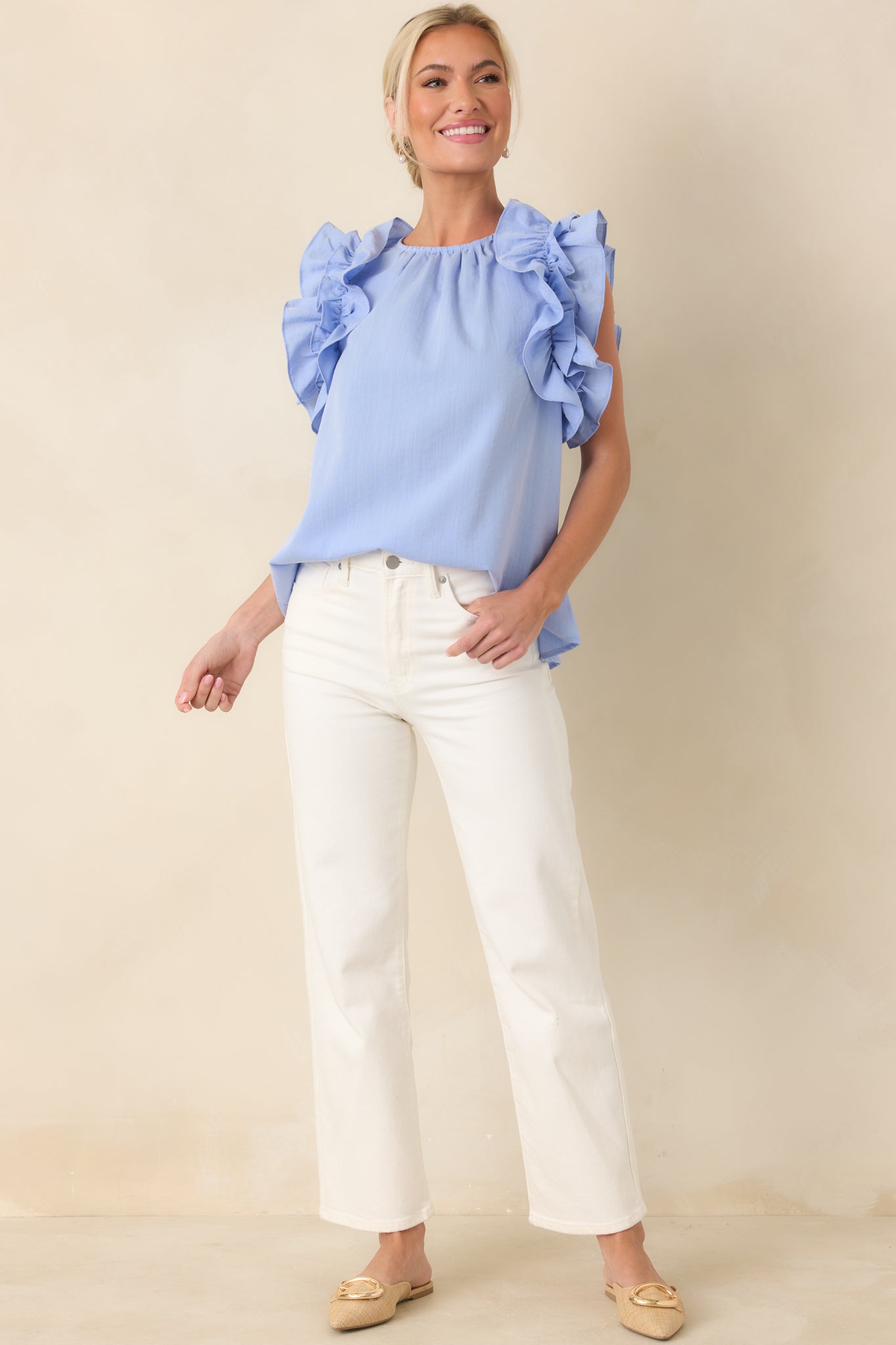 White high-rise jeans shown from the front highlighting belt loops and structured waistband.
