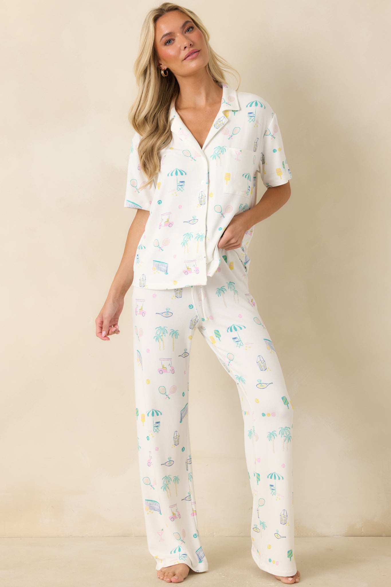 Collared pajama top in white jersey knit with a relaxed silhouette, button-front closure, and sporty resort-inspired illustrations throughout.