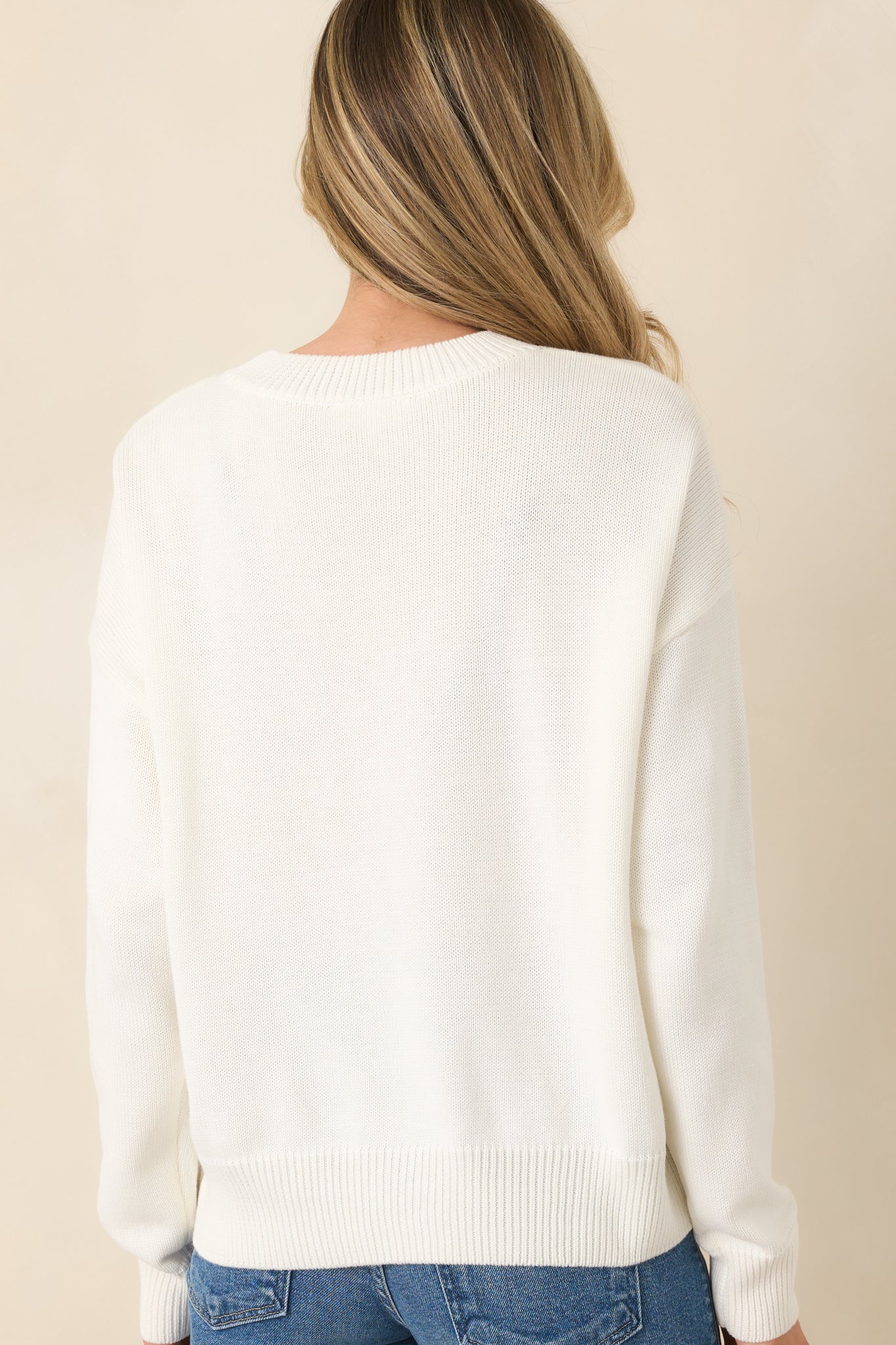 White knit pullover with relaxed fit and subtle crew neckline.